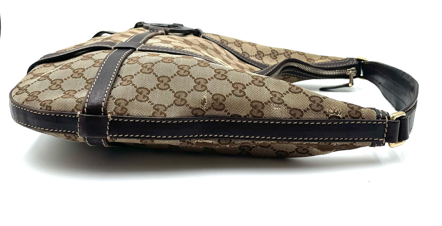 Gucci beige and brown GG canvas hobo bag with dark brown leather trim and shoulder strap on a white background.