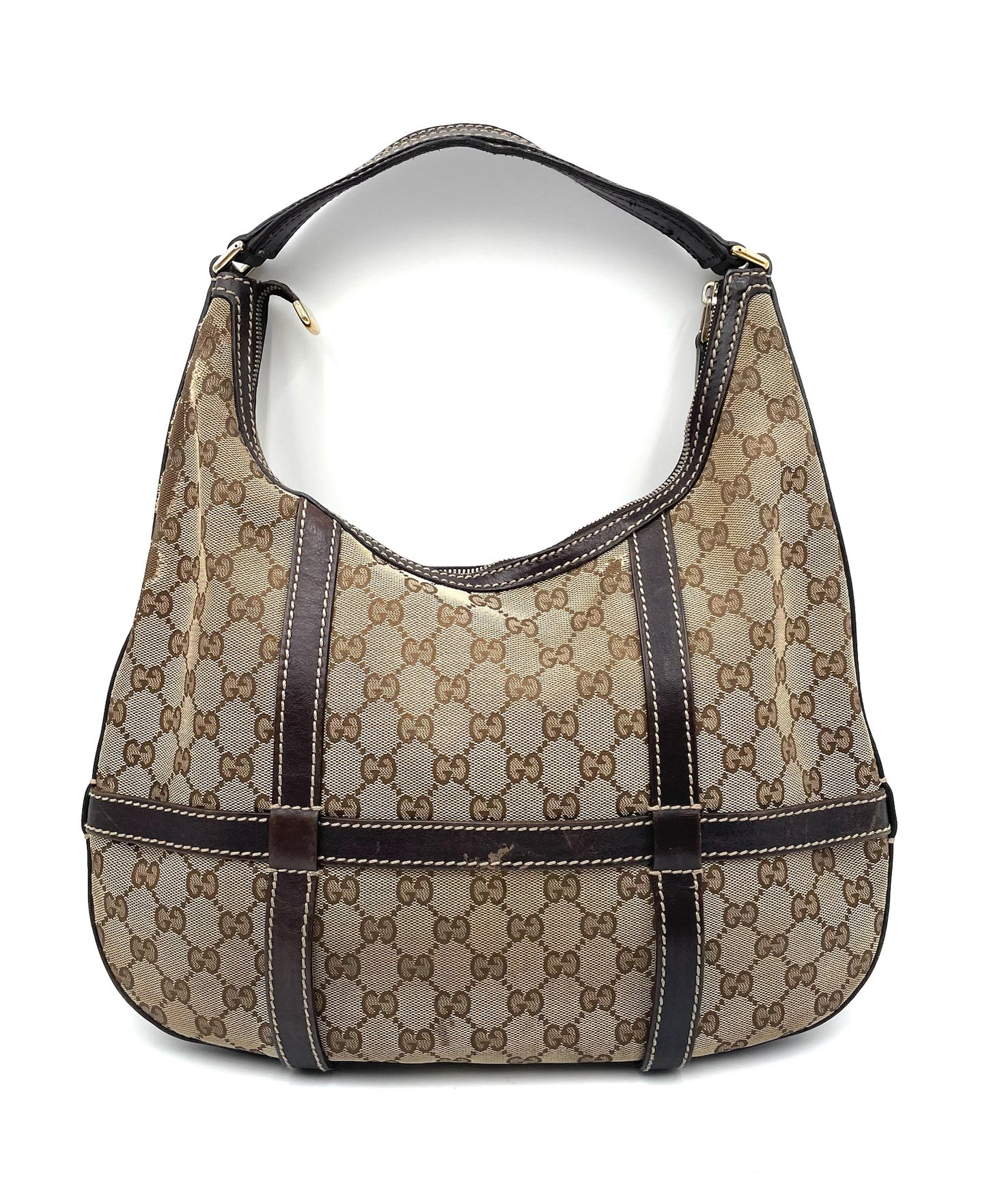 Gucci GG canvas hobo bag in beige and brown with dark leather trim, shoulder strap, and top zip closure.
