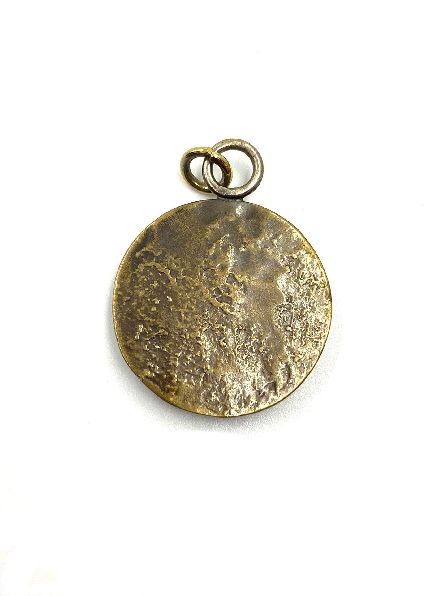 Karyn Chopik bronze round starburst pendant with a textured finish and rhinestone center.