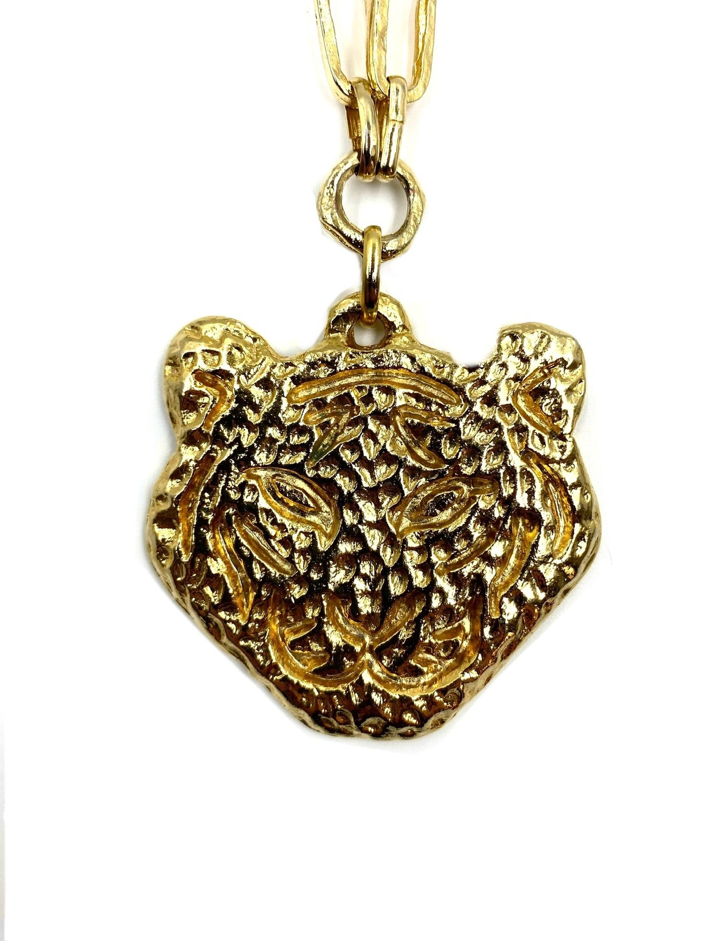 Las Surenas gold plated tiger head pendant on a long chain necklace.