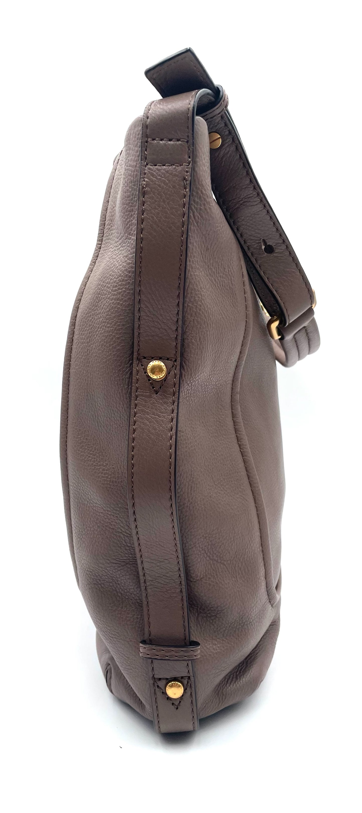 Marc Jacobs Revolution taupe leather hobo bag with gold-tone hardware and adjustable strap.