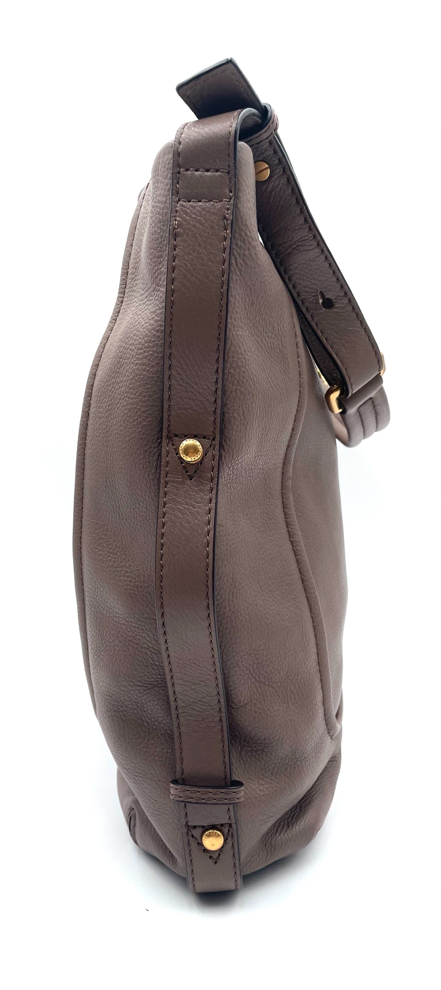 Marc Jacobs Revolution taupe leather hobo bag with gold-tone hardware and adjustable strap.