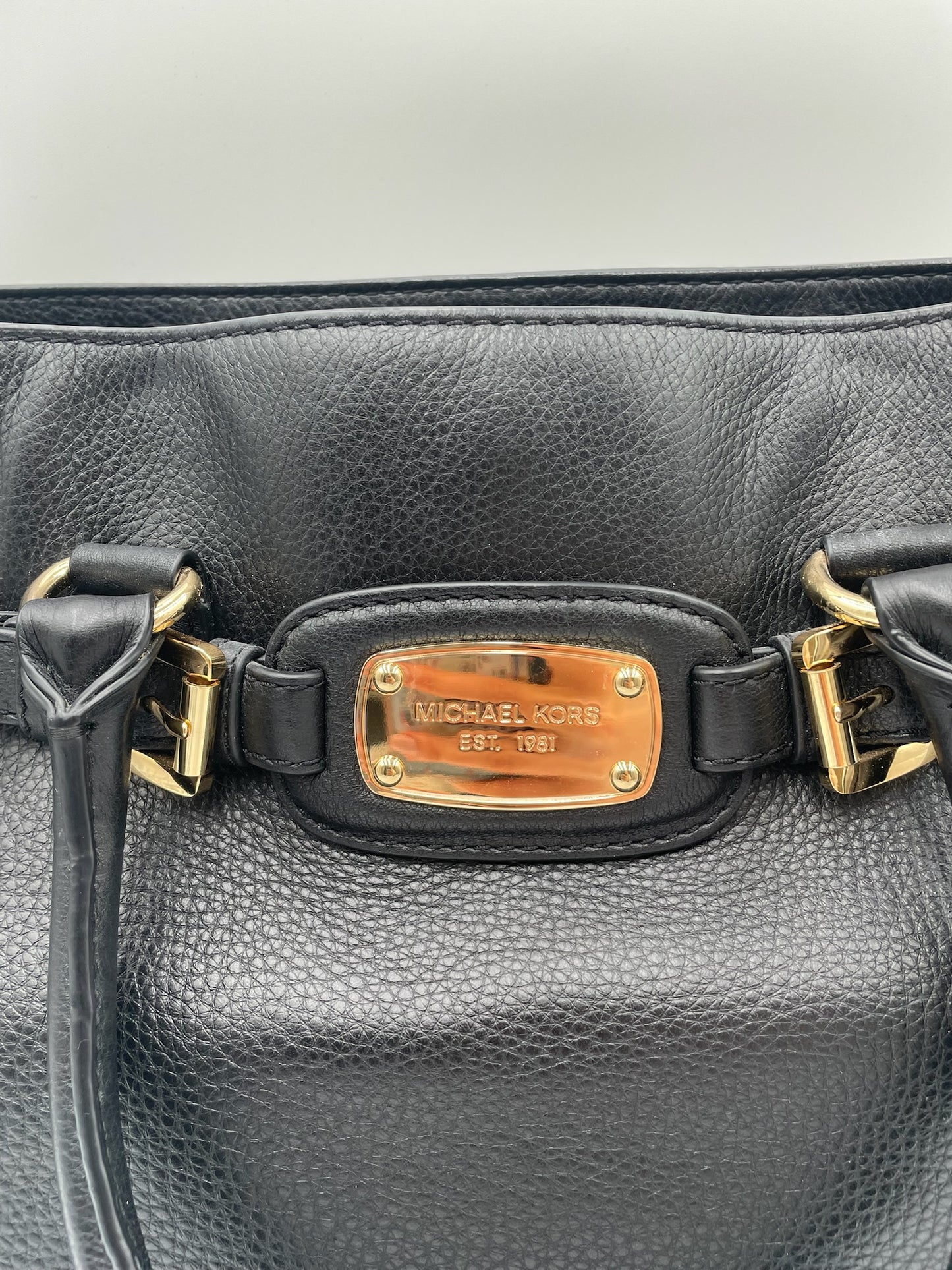 Michael Kors Black Hamilton East West pebbled leather tote with polished gold-tone hardware and logo plaque.