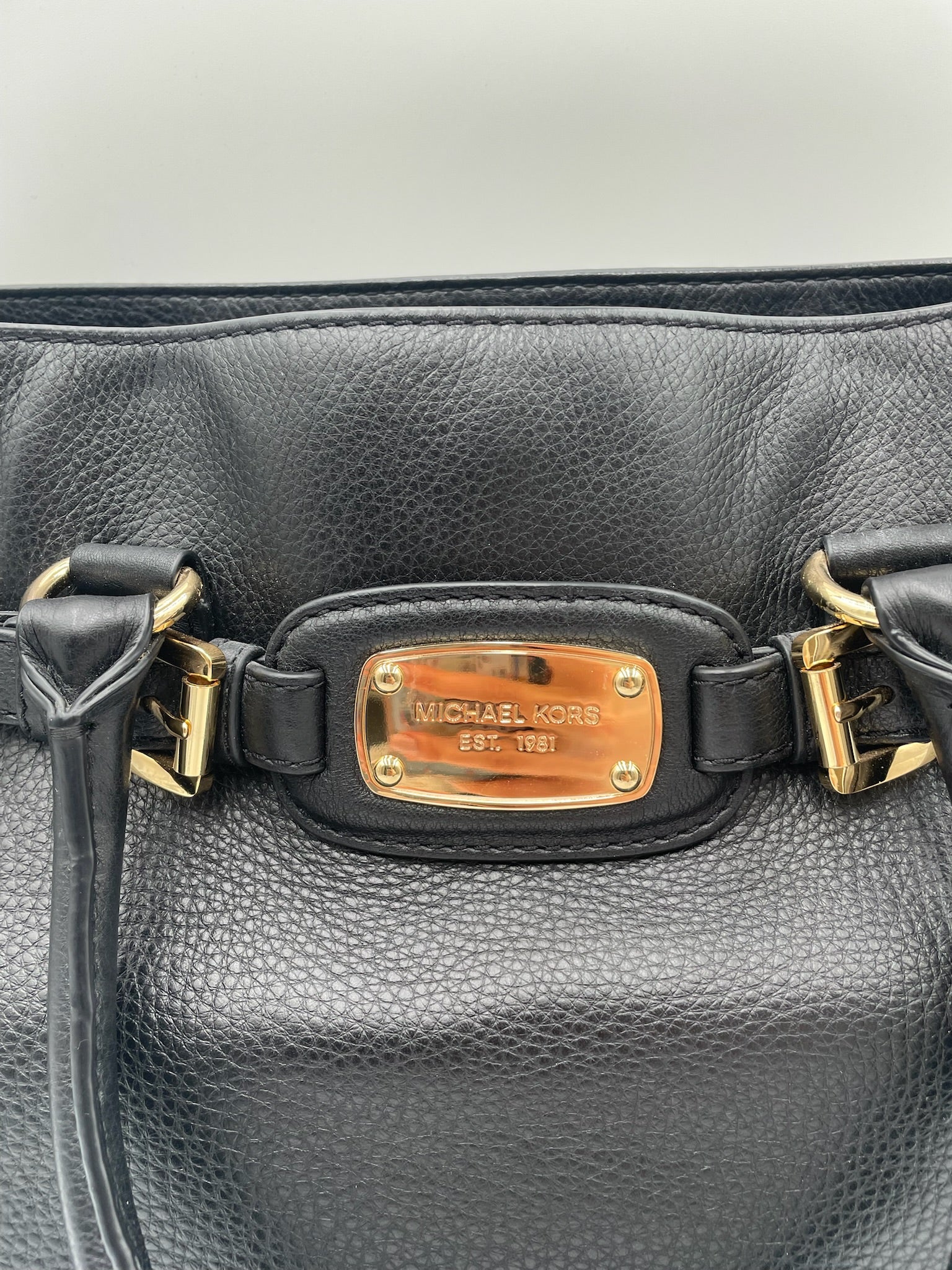 Michael Kors Black Hamilton East West pebbled leather tote with polished gold-tone hardware and logo plaque.