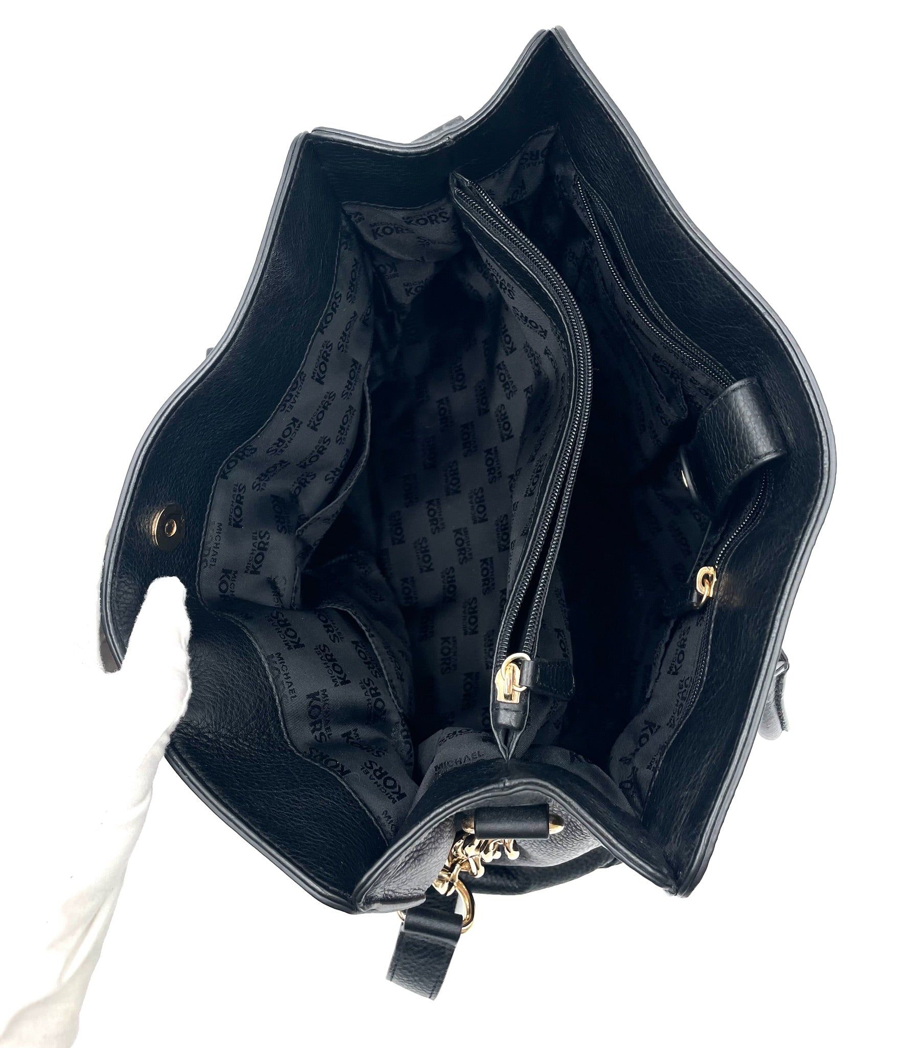Michael Kors Black Hamilton East West pebbled leather tote, open to show logo lining and interior pockets.
