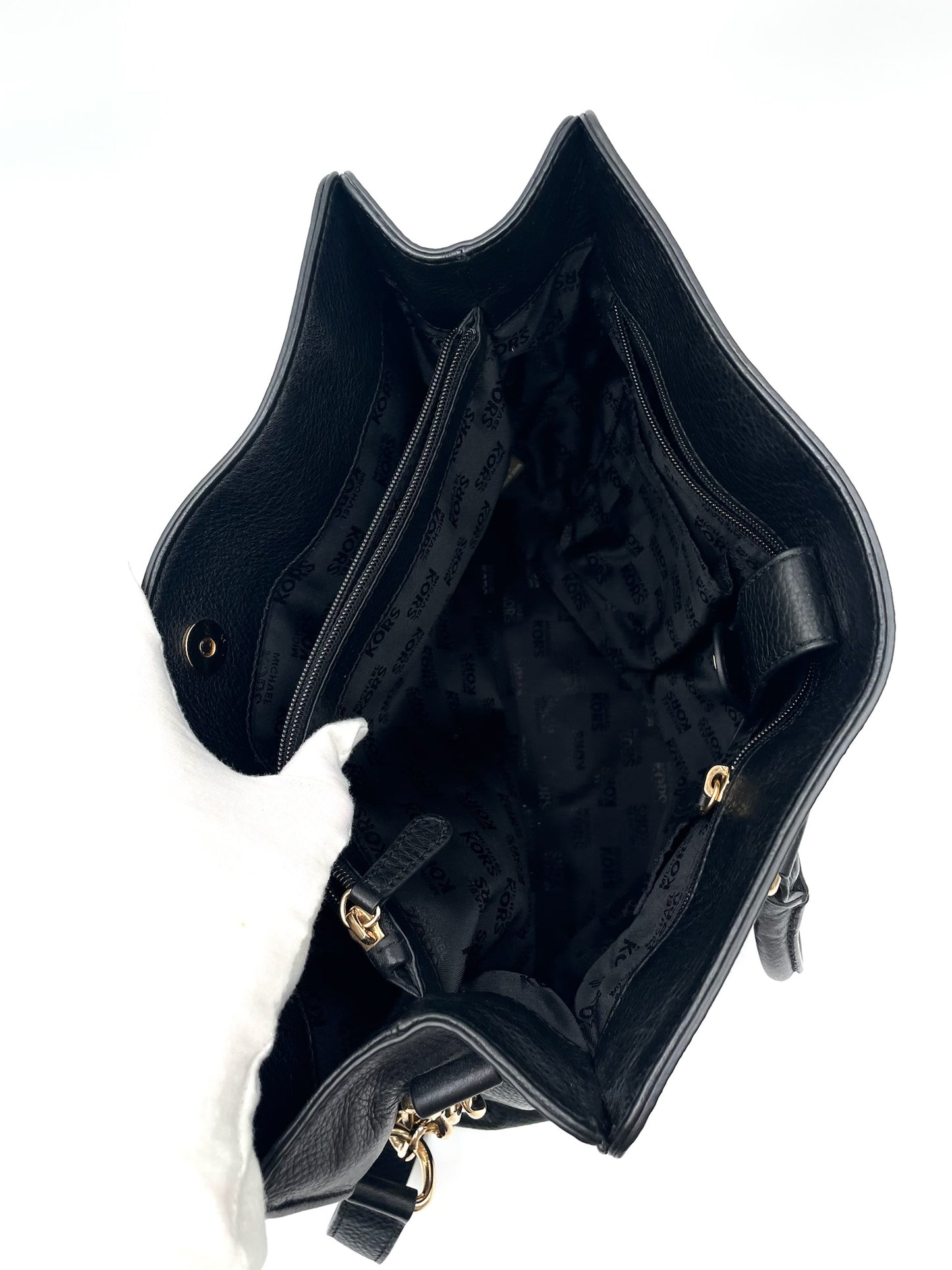 Open black pebbled leather Michael Kors Hamilton tote showing interior lining, zipper pockets, and gold hardware.