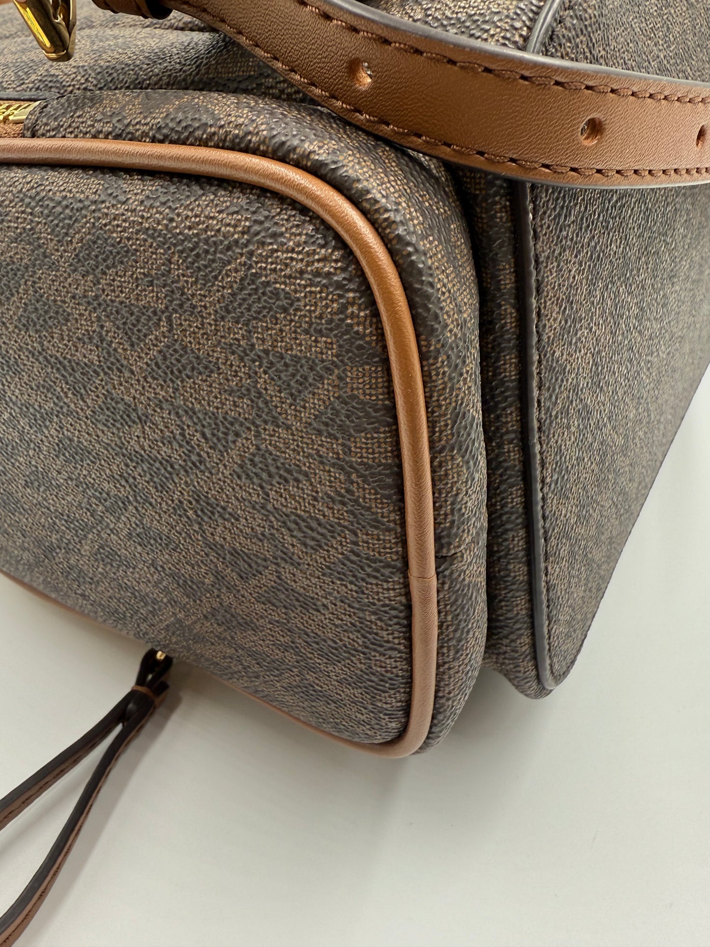 Michael Kors large logo Jet Set backpack in brown monogram canvas with tan leather trim.