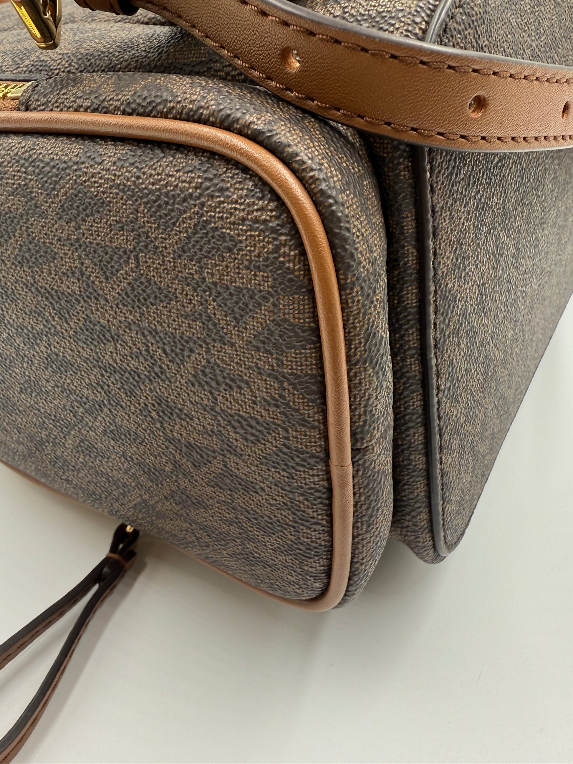 Michael Kors large logo Jet Set backpack in brown monogram canvas with tan leather trim.