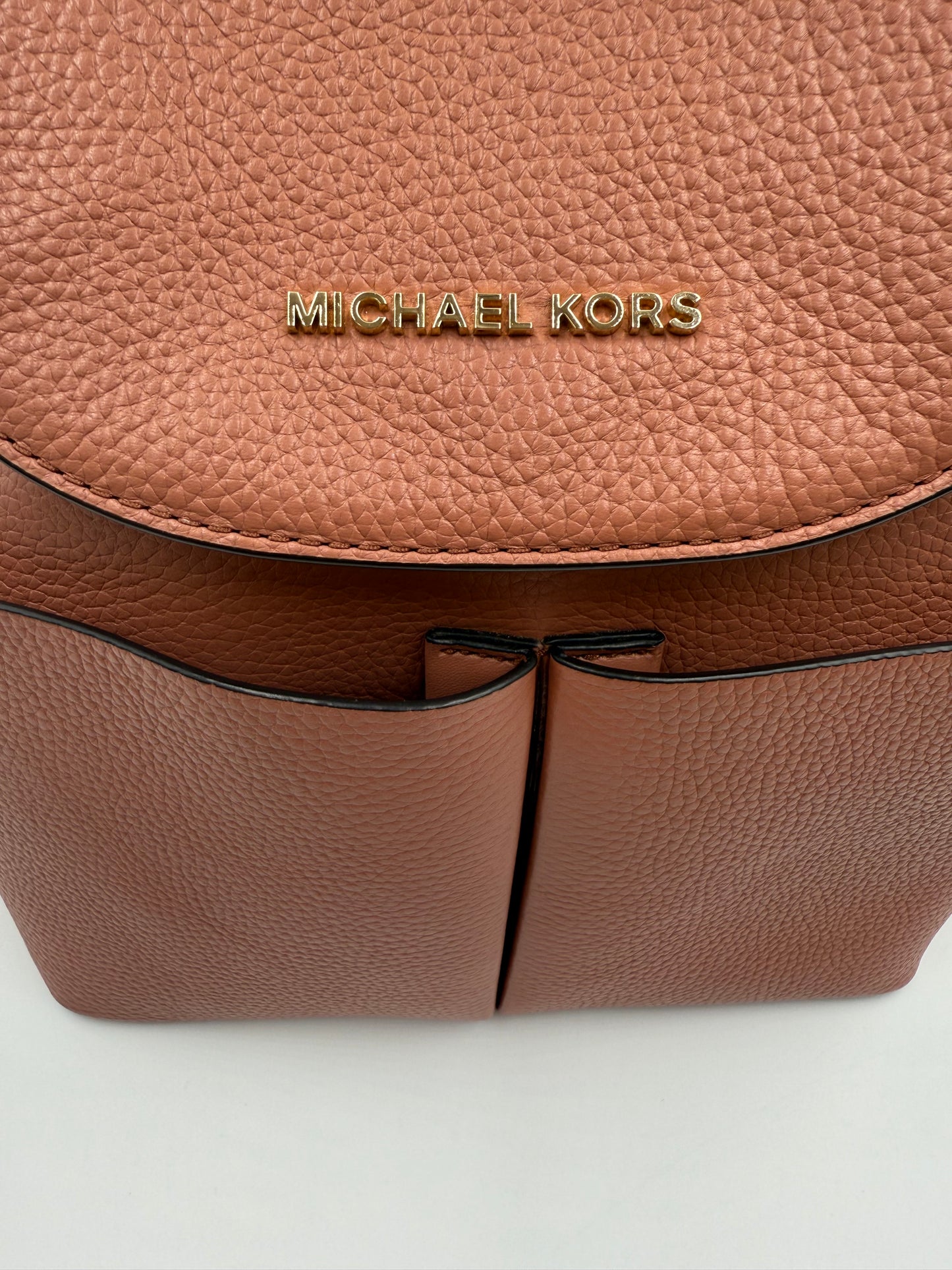 Michael Kors Peach Bedford large leather convertible backpack with gold-tone logo and front slip pockets.