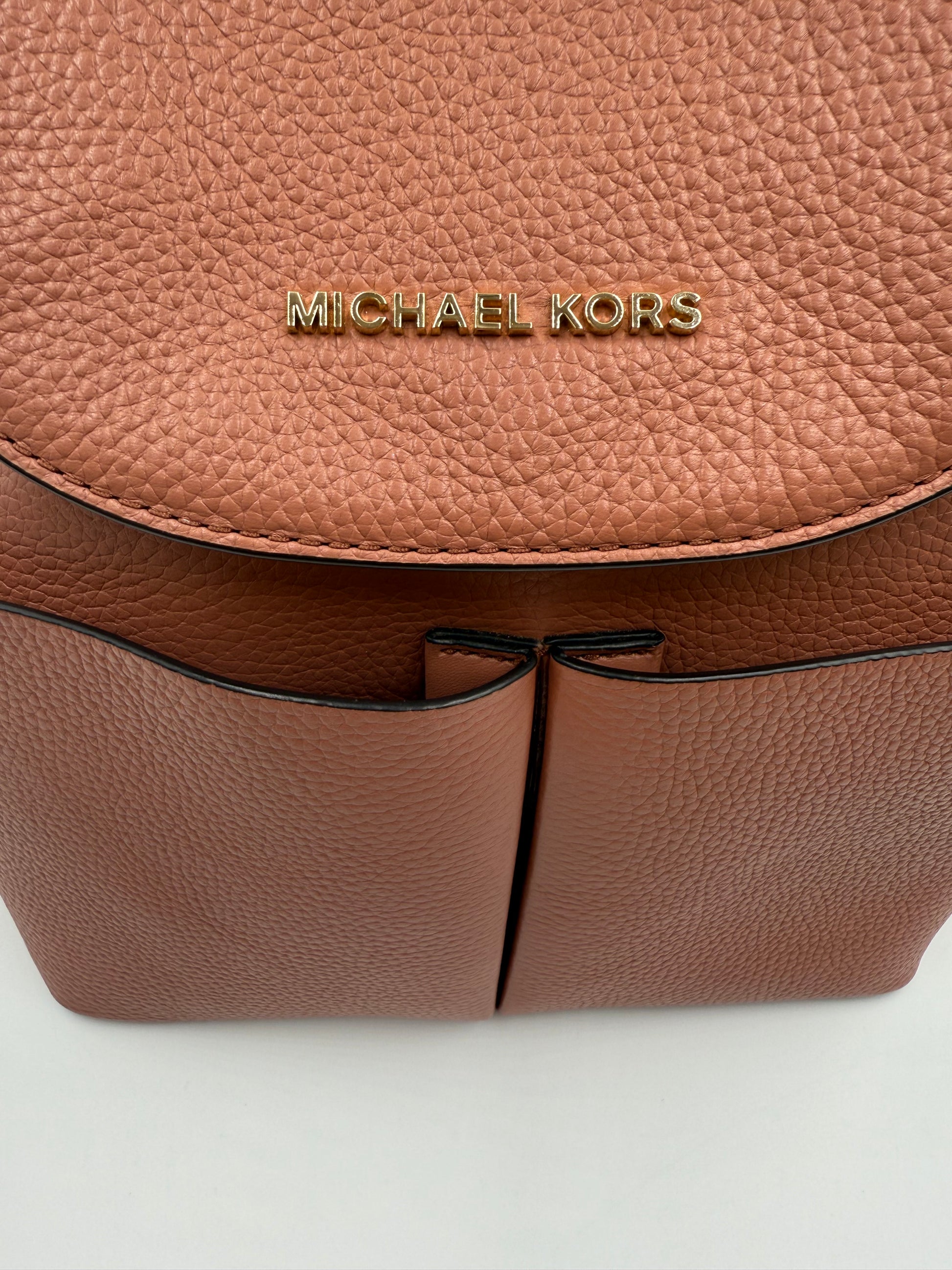 Michael Kors Peach Bedford large leather convertible backpack with gold-tone logo and front slip pockets.