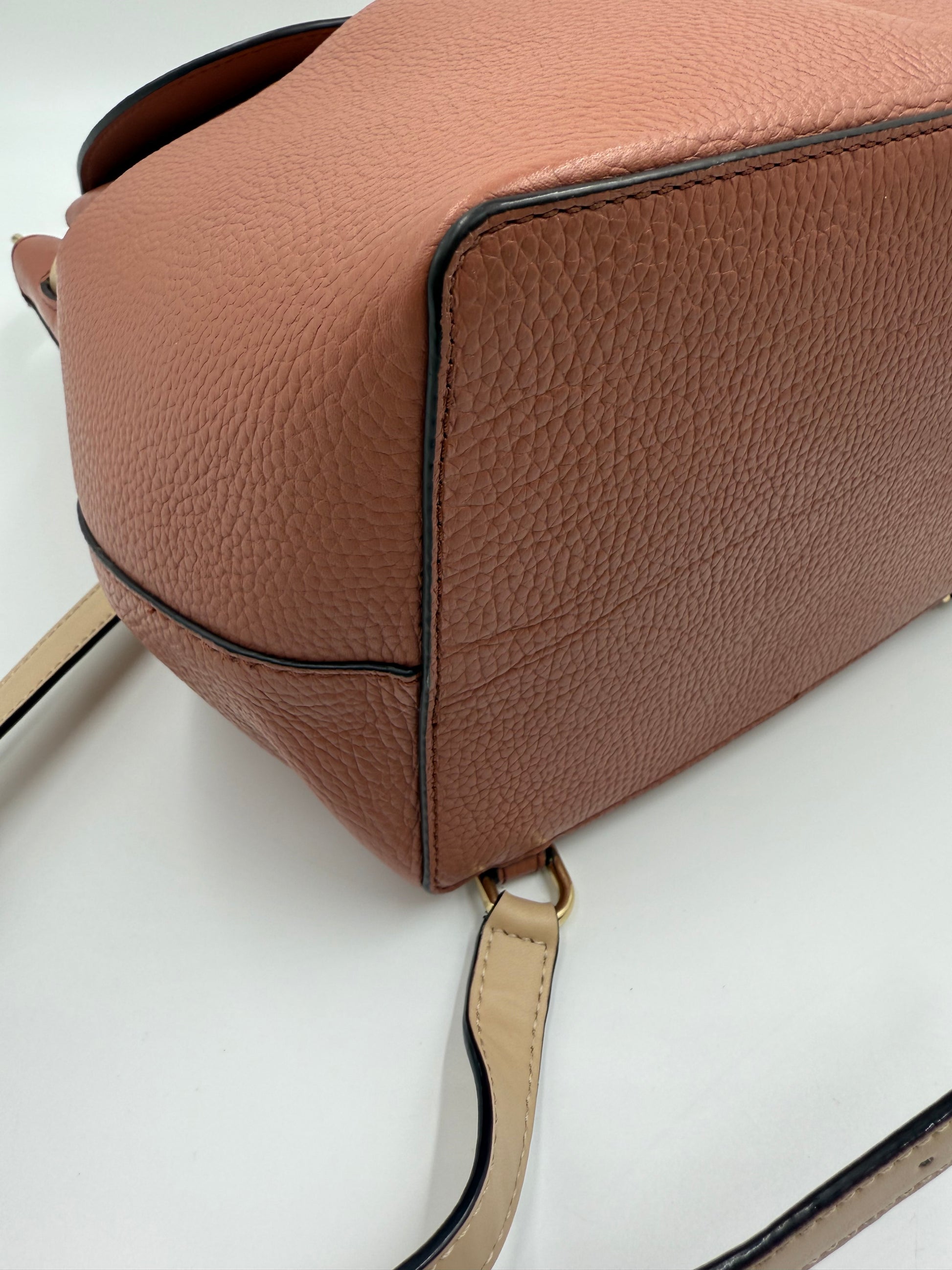Michael Kors Peach Bedford large pebbled leather convertible backpack with light straps and gold hardware.