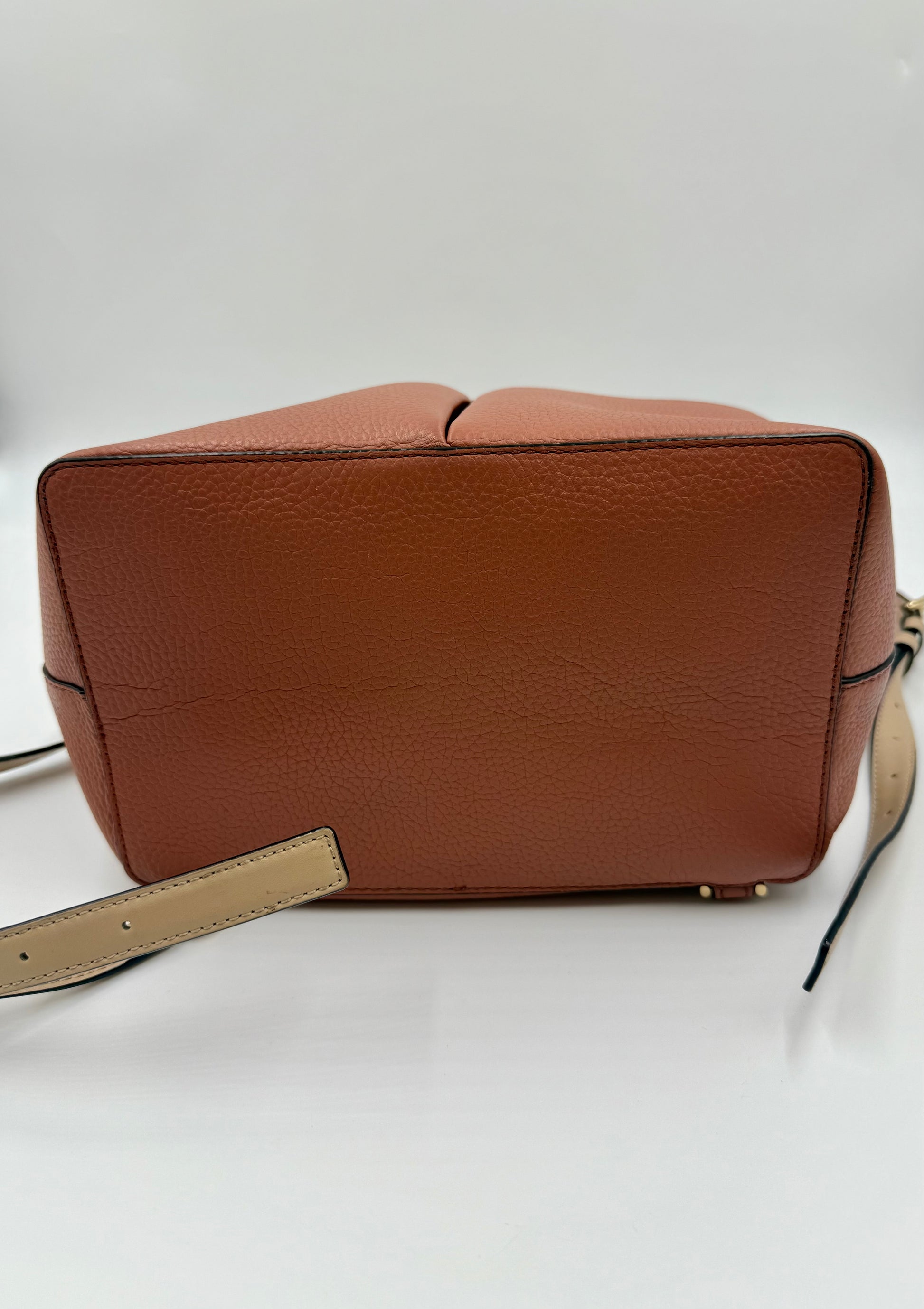 Michael Kors Peach Bedford large leather convertible backpack bottom with gold-tone hardware.