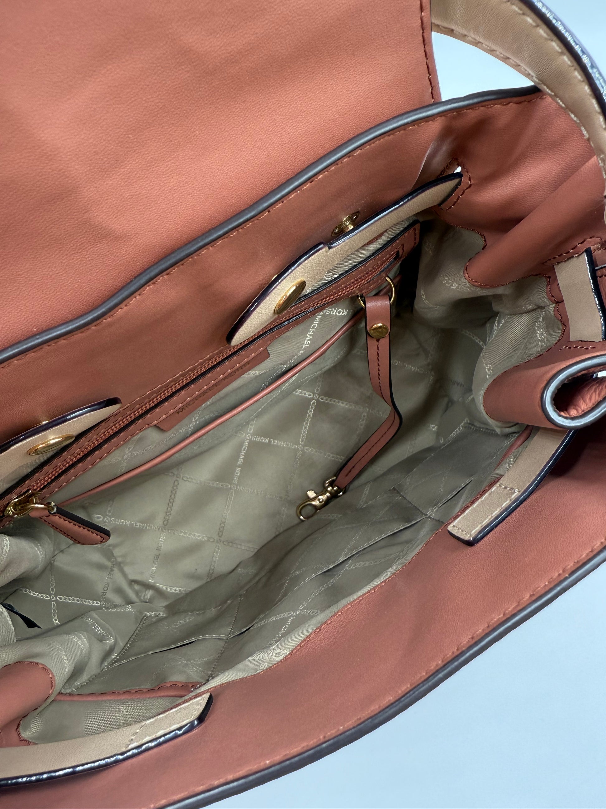 Open Michael Kors Peach Bedford large leather convertible backpack, showing spacious interior with pockets.