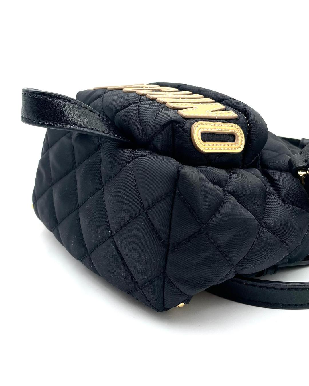 Black quilted nylon Moschino mini backpack with gold logo lettering and zip pocket detail.