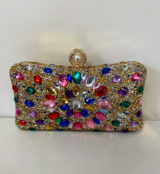 Rectangular clutch covered in gold glitter and vibrant, multi-colored rhinestones with a pearl-style clasp.
