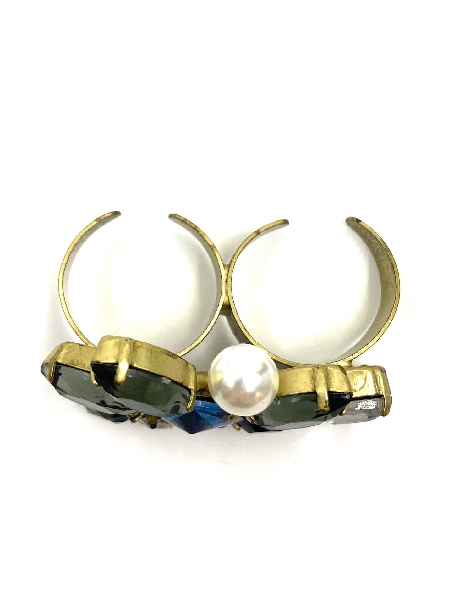 Adjustable gold tone double finger ring with multicolor rhinestones and a central white pearl.