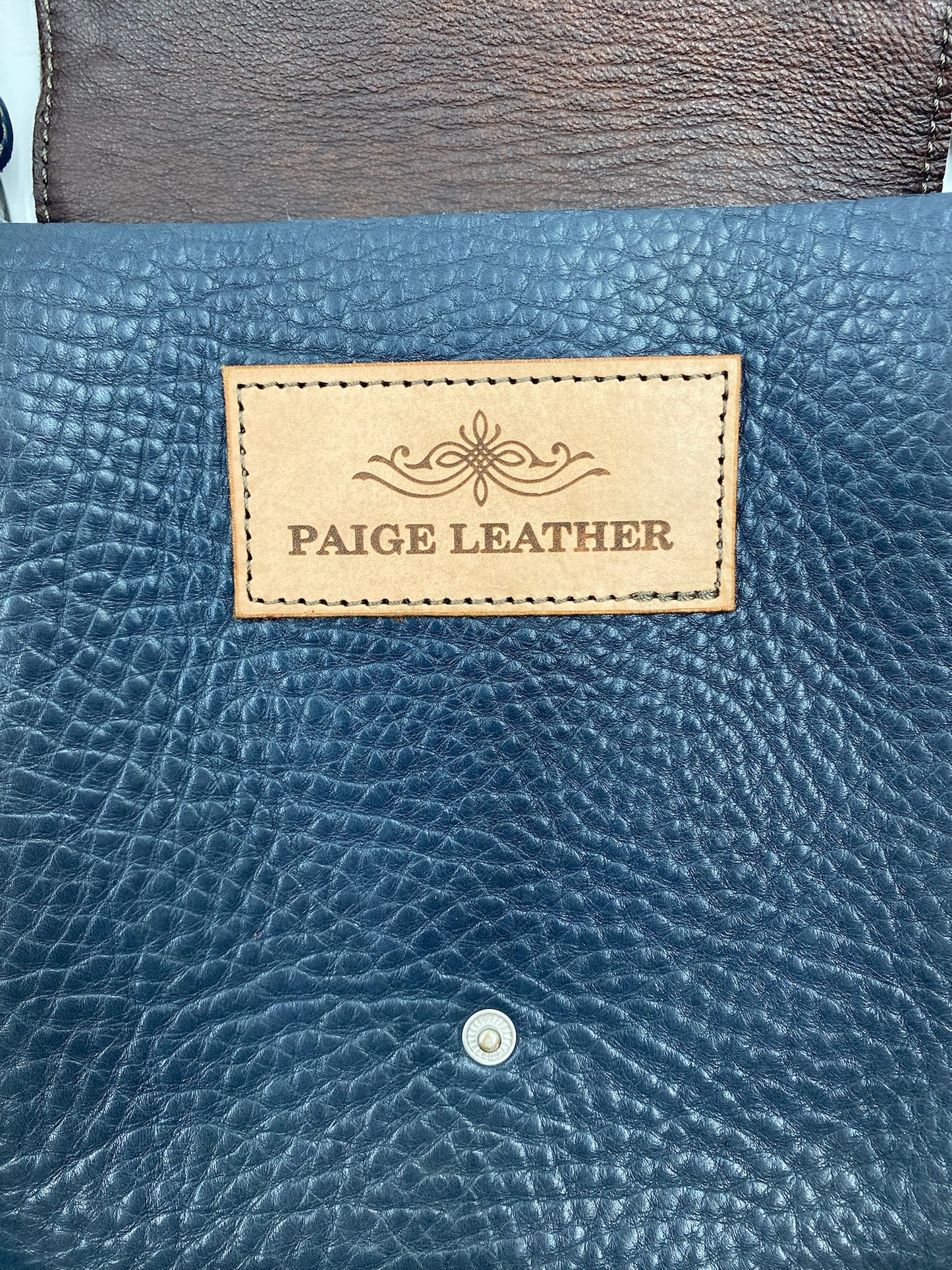Navy fringe leather crossbody bag with Paige Leather brand patch and silver magnetic closure.