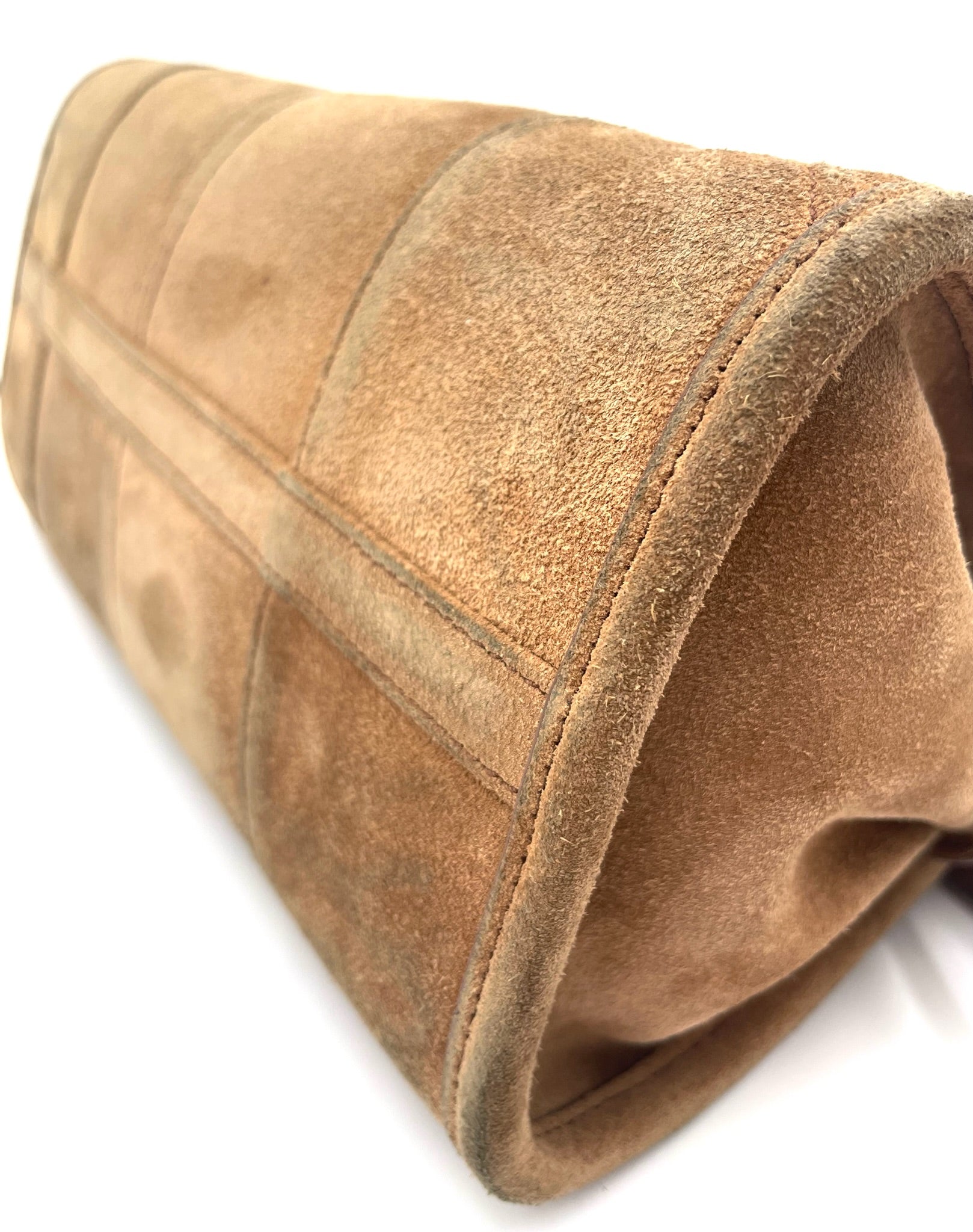 Cinnamon brown suede Prada Bonnie small shoulder bag with panelled construction and visible texture.