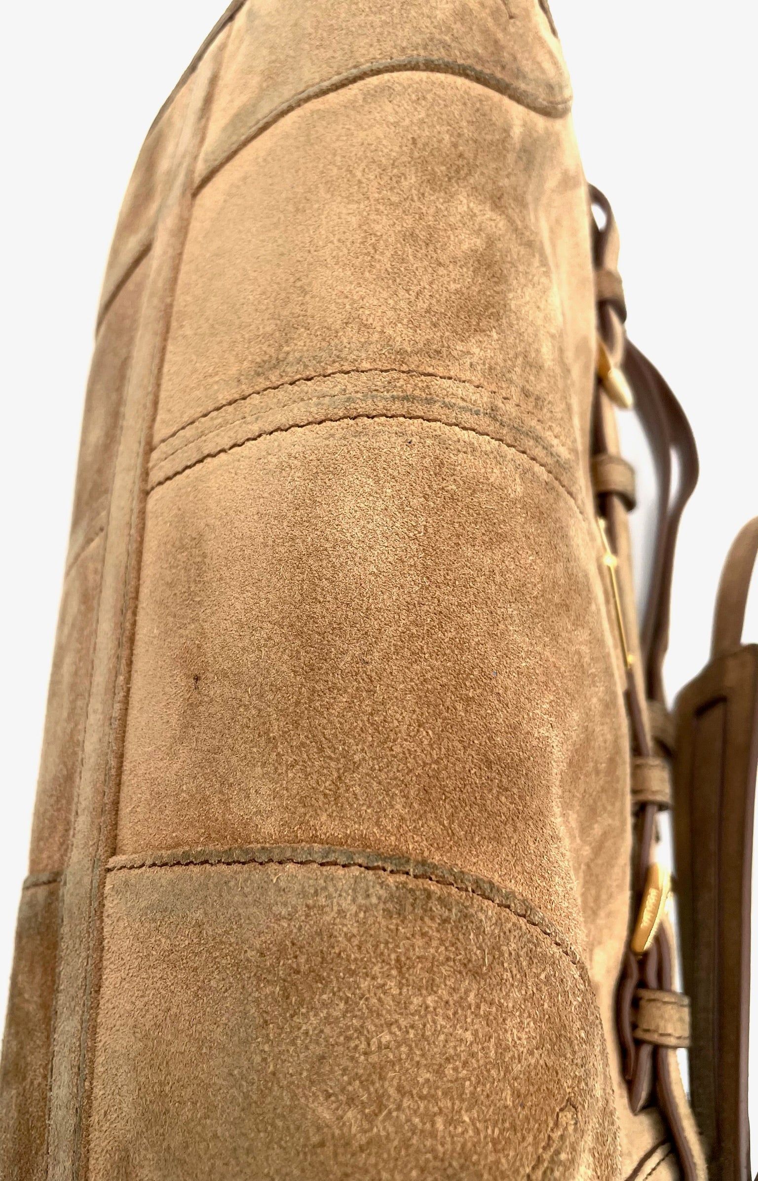 Cinnamon brown Prada Bonnie small suede shoulder bag featuring stitched paneling and gold hardware details.
