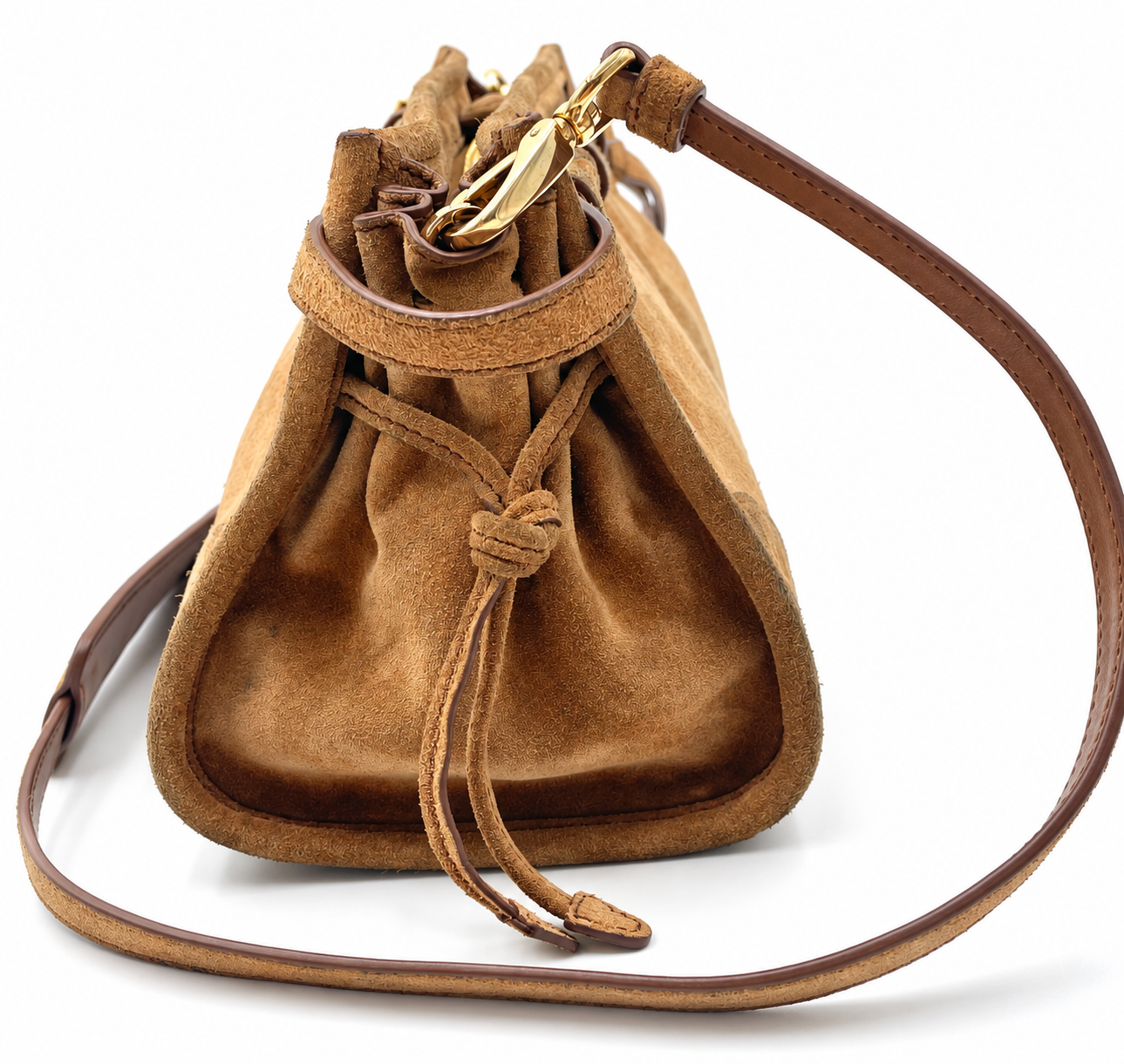 Prada cinnamon brown suede Bonnie shoulder bag with gold hardware and drawstring side detail on a white background.