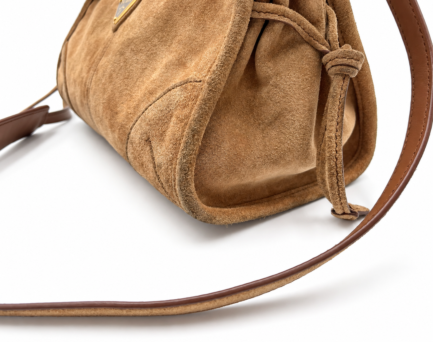Prada Bonnie small cinnamon brown suede shoulder bag with a long strap and gold hardware details.