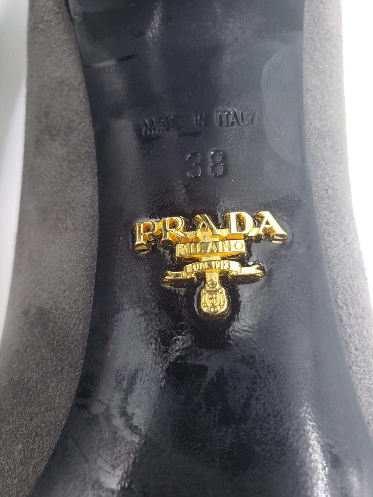 Prada grey suede pump sole with gold logo, "Made in Italy" and "38" size stamp.