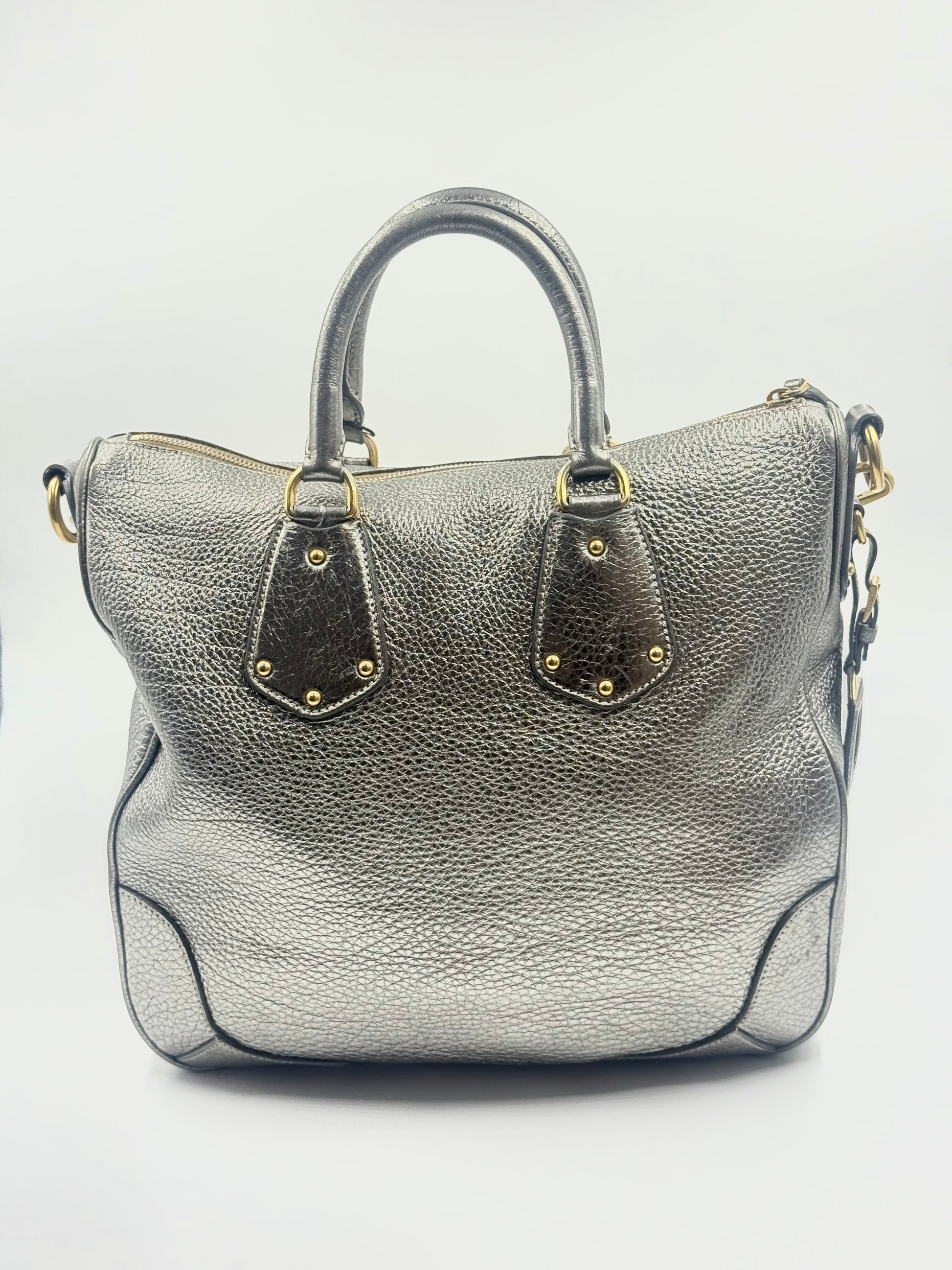 Prada Silver Metallic Vitello Daino Tote with rolled handles, gold-tone hardware, and front logo.