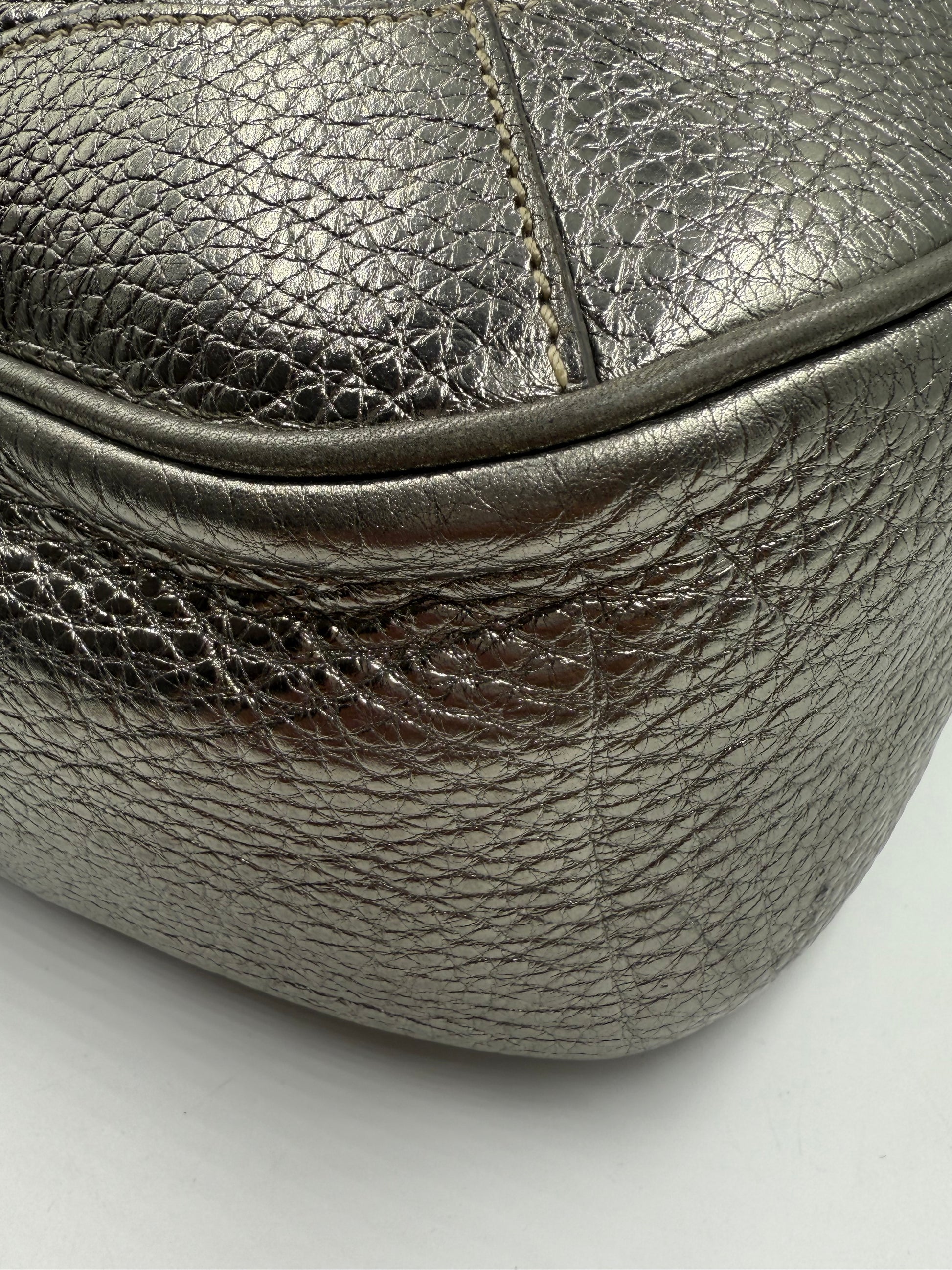 Prada Silver Metallic Vitello Daino Tote, close-up of textured leather and stitching.