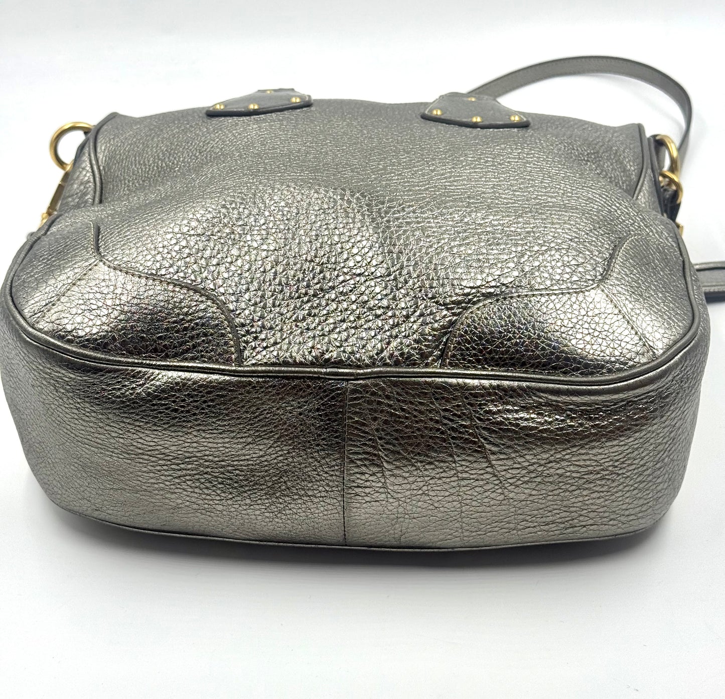 Prada metallic silver Vitello Daino tote with textured leather, gold-tone hardware, and rolled top handles.