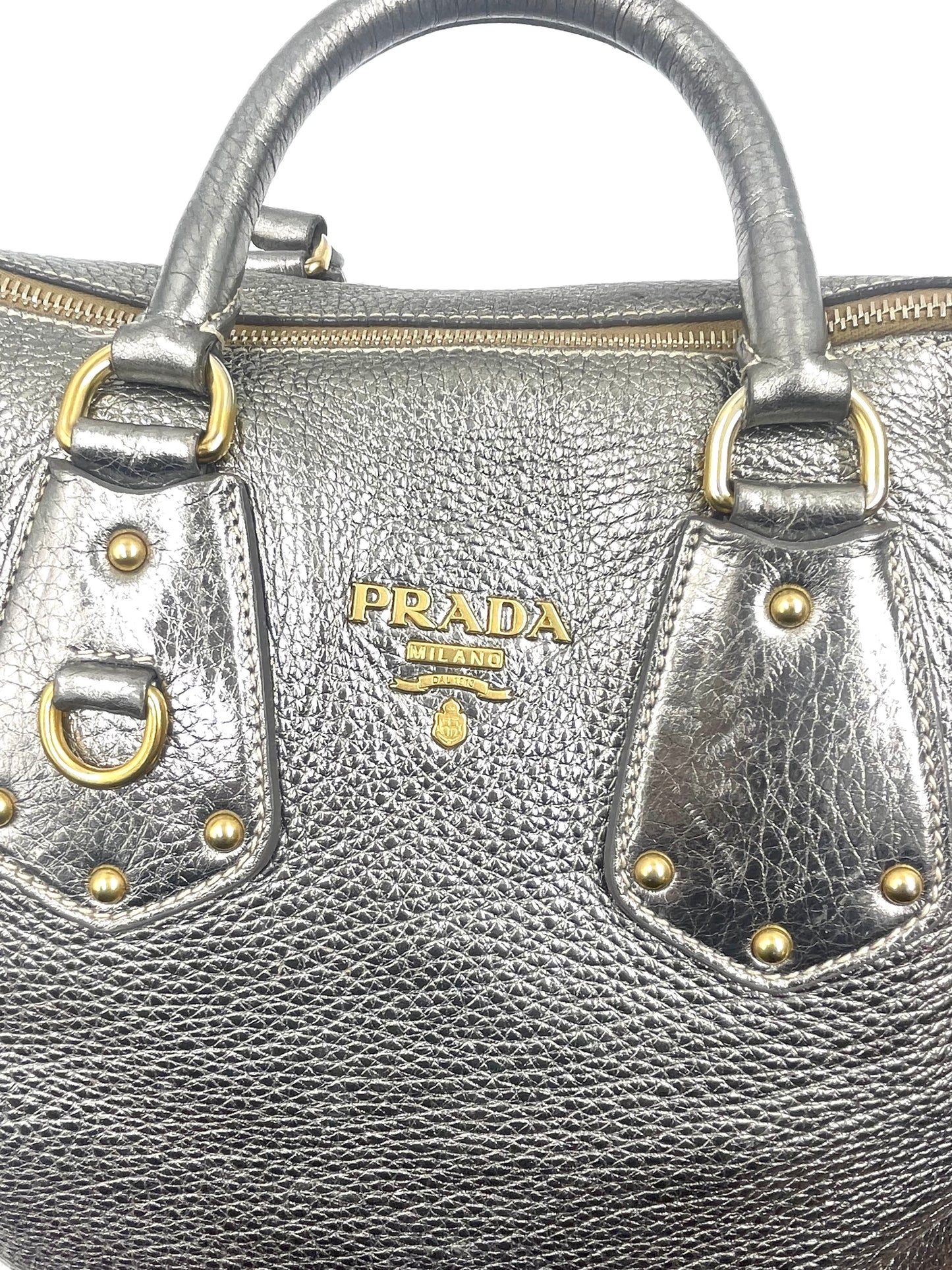 Prada Silver Metallic Vitello Daino Tote with gold-tone hardware, rolled handles, and front logo.