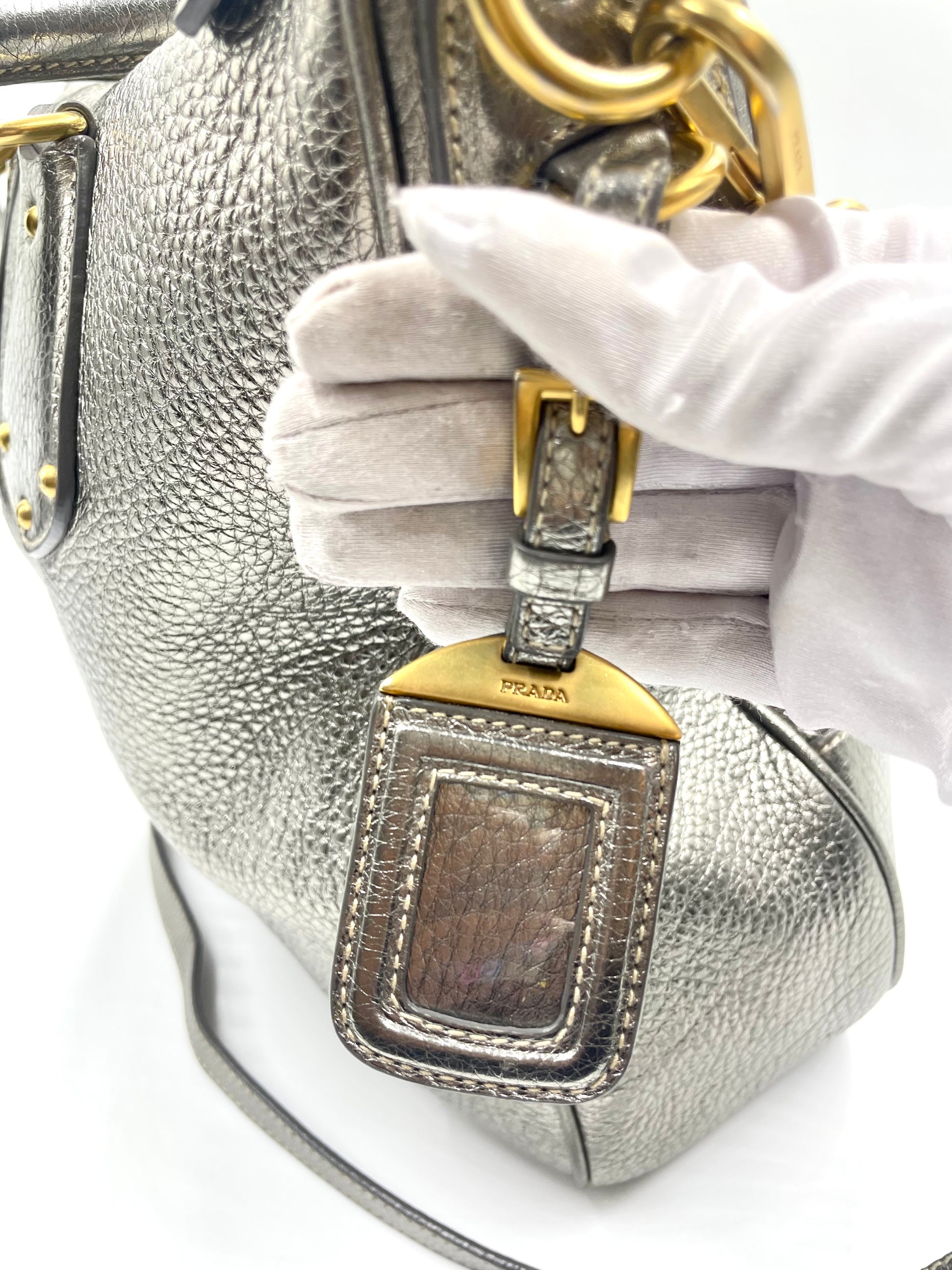 Prada silver metallic Vitello Daino tote with gold-tone hardware and removable ID tag.