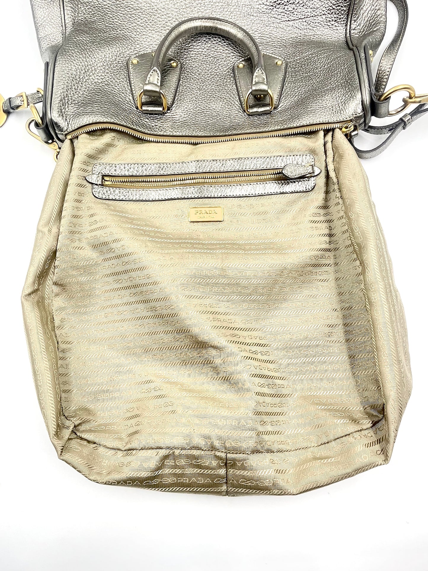 Prada silver metallic Vitello Daino tote, open to show textile-lined interior with zip pocket and logo.