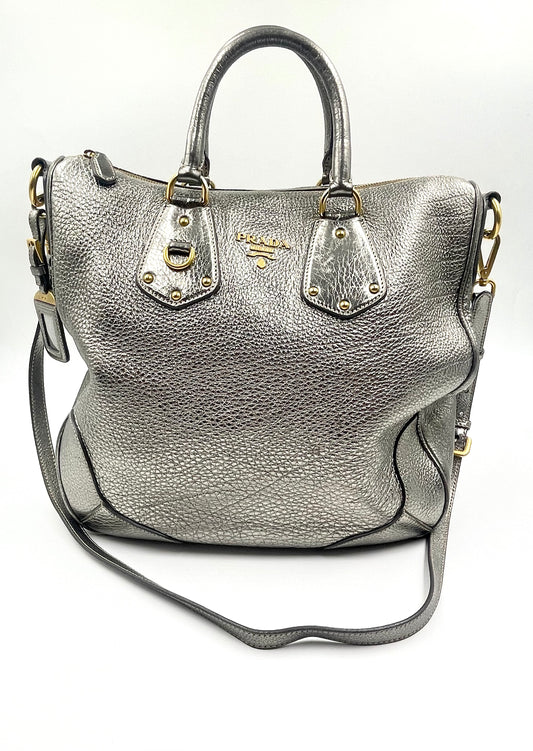 Prada Silver Metallic Vitello Daino Tote with rolled handles, gold hardware, and front logo.