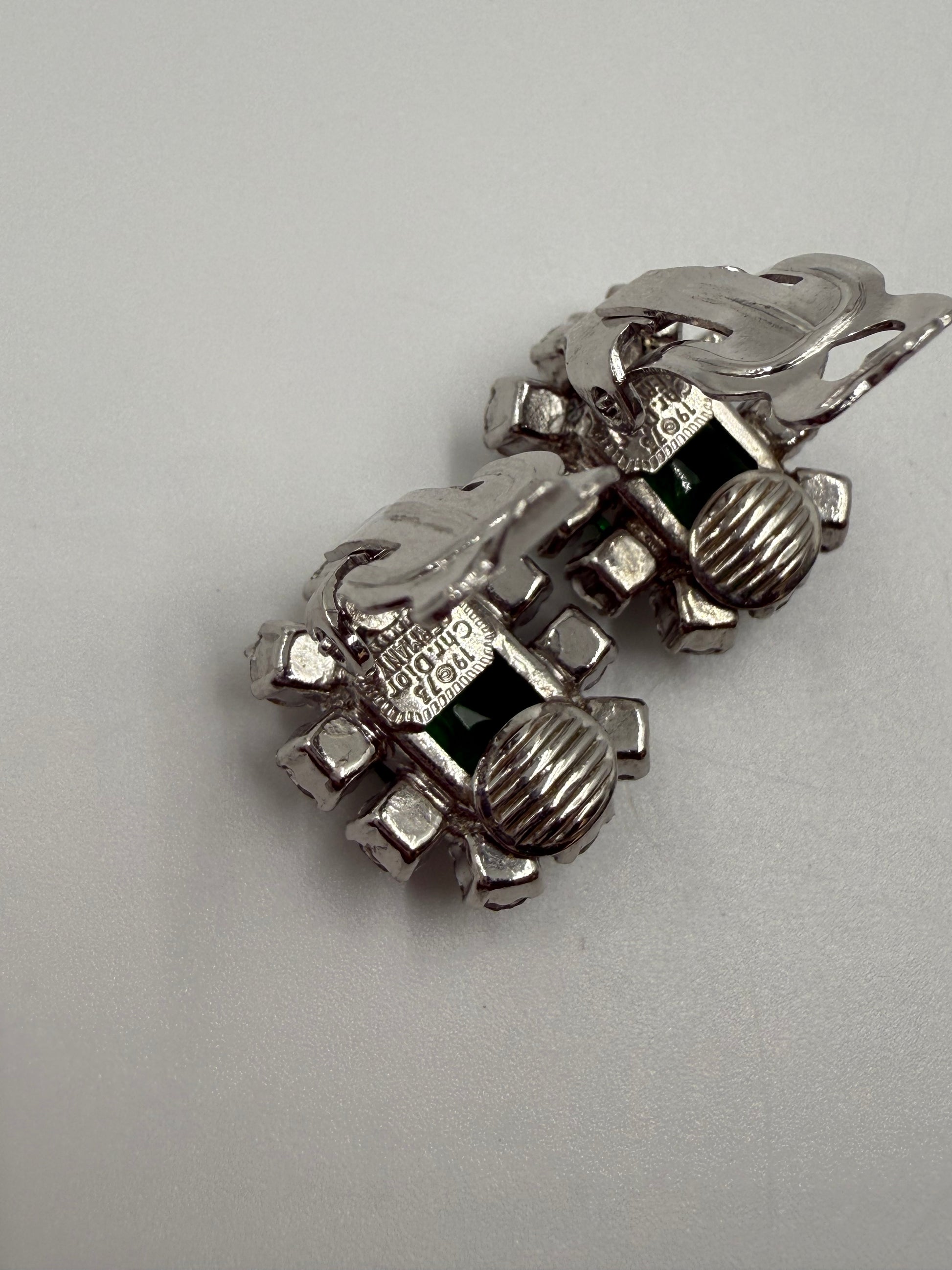 Rare 1973 Christian Dior silver-tone clip earrings with emerald glass cabochons and clear crystal rhinestones.