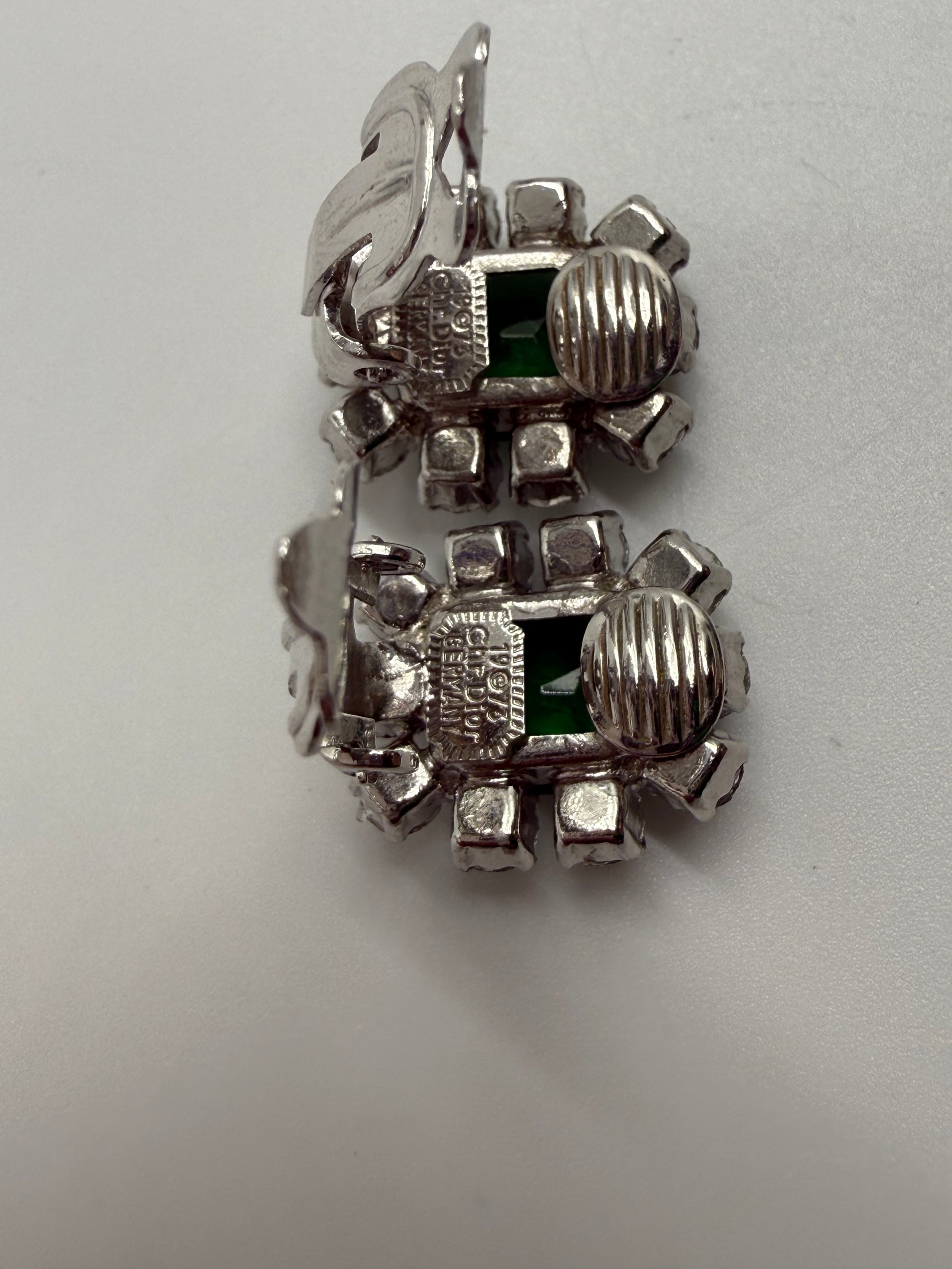 Rare 1973 Christian Dior silver-tone clip earrings with emerald glass cabochons and clear crystal rhinestones.
