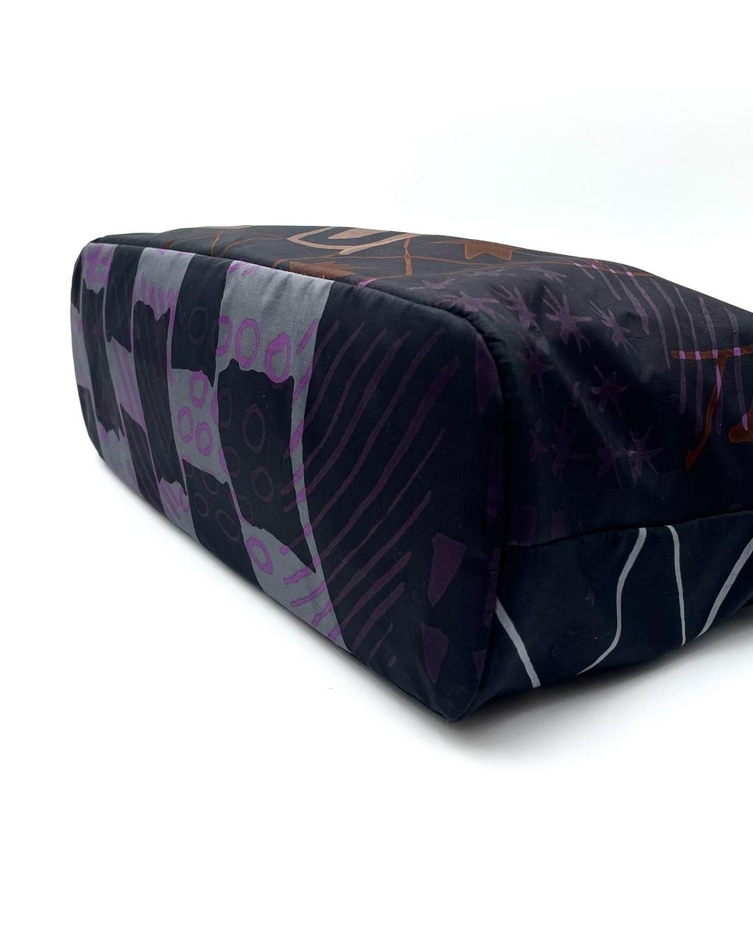 Salvatore Ferragamo black nylon tote with purple and grey abstract geometric pattern and line art details.