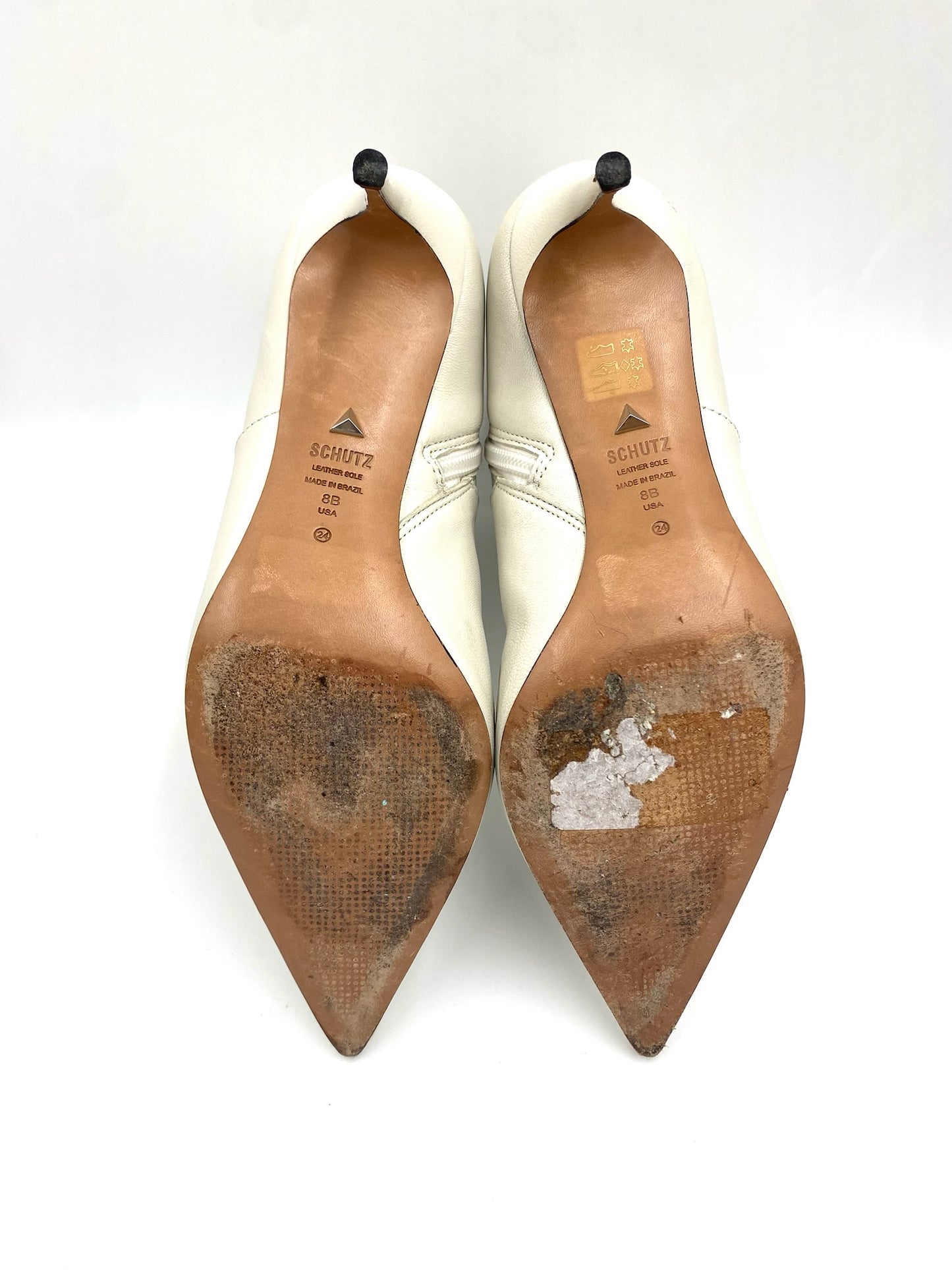 Schutz white leather pointed ankle boots, size 8B, showing worn brown soles and heels.