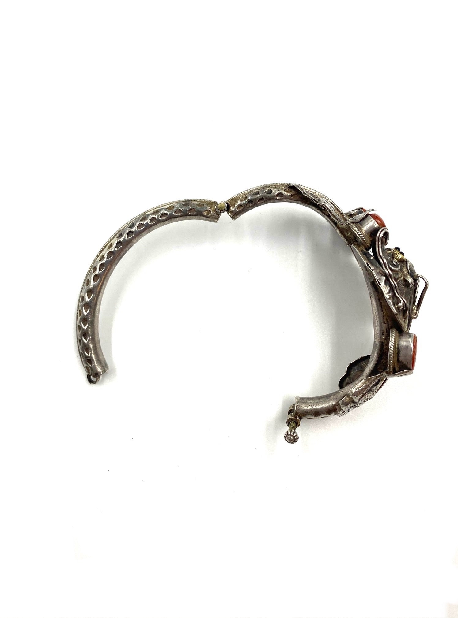 Sculpted sterling silver dragon bracelet with red coral cabochons and intricate high-relief details.