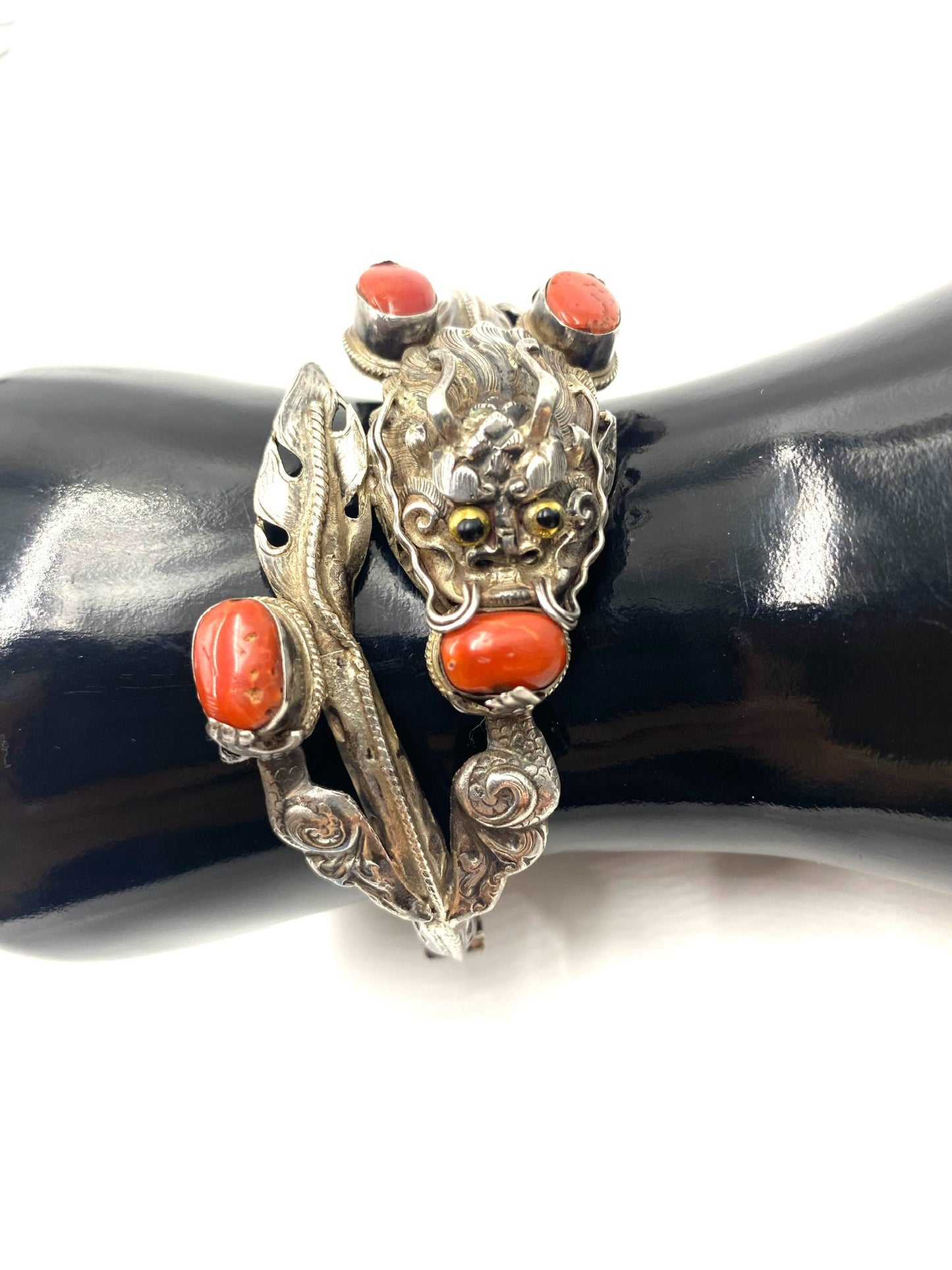 Sculpted sterling silver antique Chinese dragon bracelet with red coral cabochons.