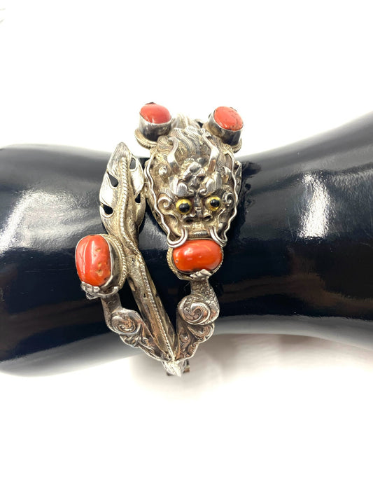 Sculpted sterling silver antique Chinese dragon bracelet with red coral cabochons.
