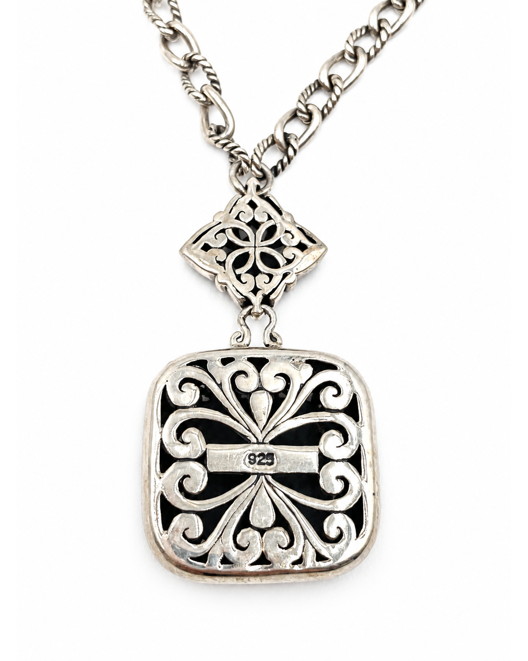 Two-tone sterling silver pendant necklace with square scrollwork charm, floral connector, and stamped 925 hallmark.