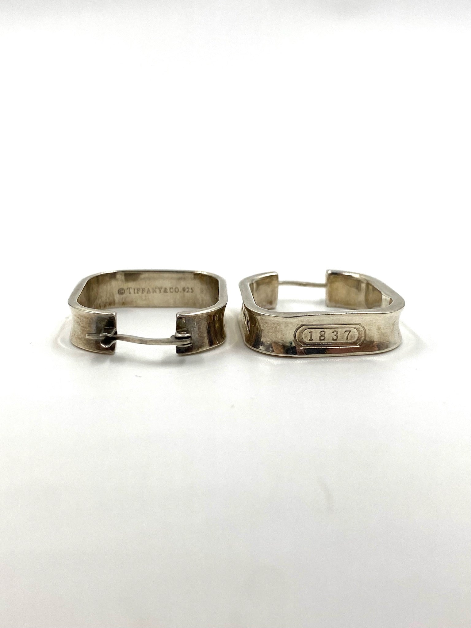 Tiffany & Co. 1837 sterling silver square hoop earrings with "1837" engraving.