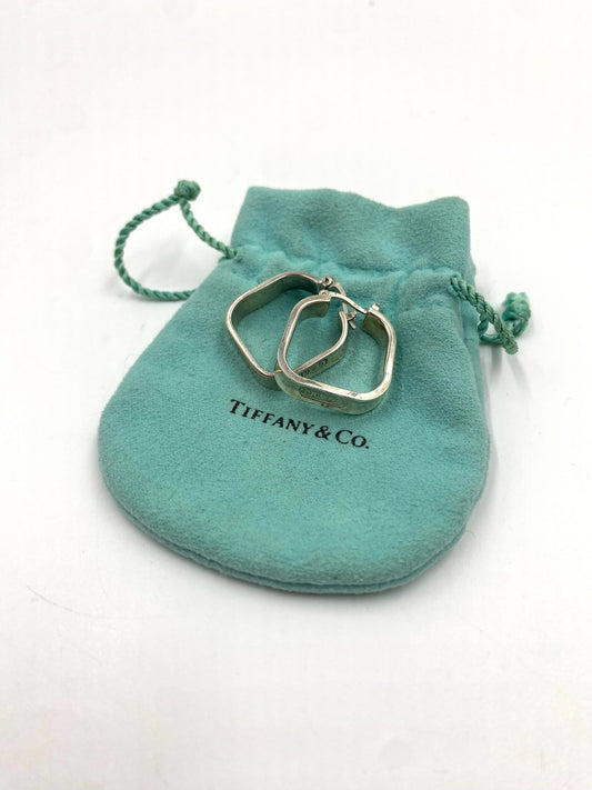 Tiffany & Co. 1837 sterling silver square hoop earrings on a Tiffany blue pouch.