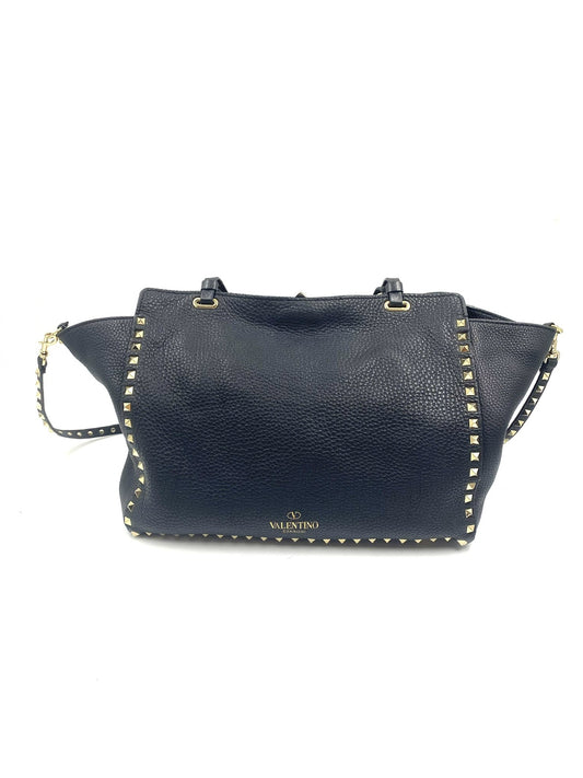 Valentino Garavani black pebbled leather Rockstud tote bag with gold hardware and studs.