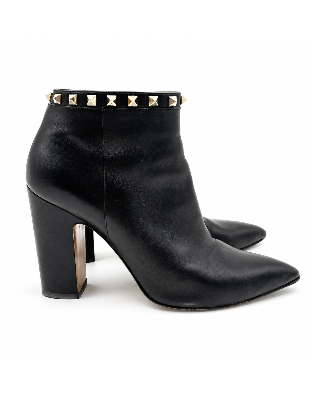 Valentino Garavani black leather pointed-toe ankle booties with gold stud trim and block heels.