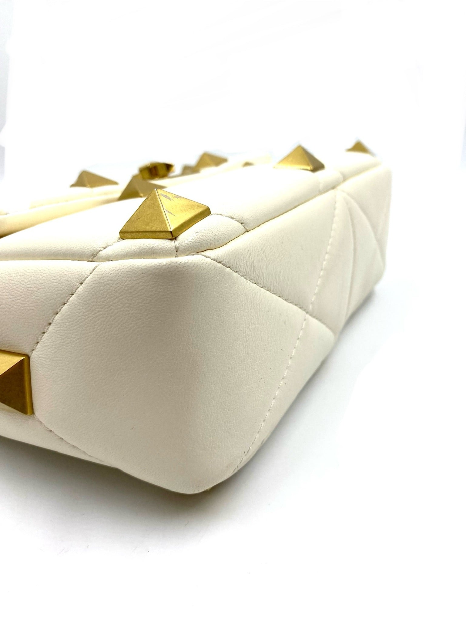 Valentino Garavani White Medium Roman Stud Bag, quilted leather with gold pyramid studs.