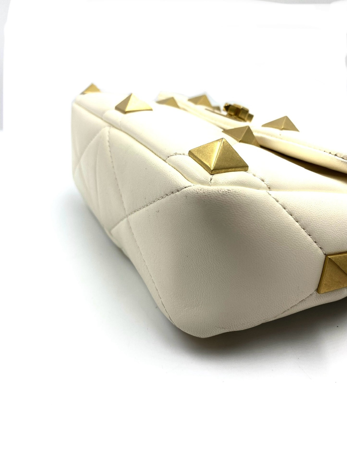 Valentino Garavani White Medium Roman Stud Bag, quilted leather with gold pyramid studs.
