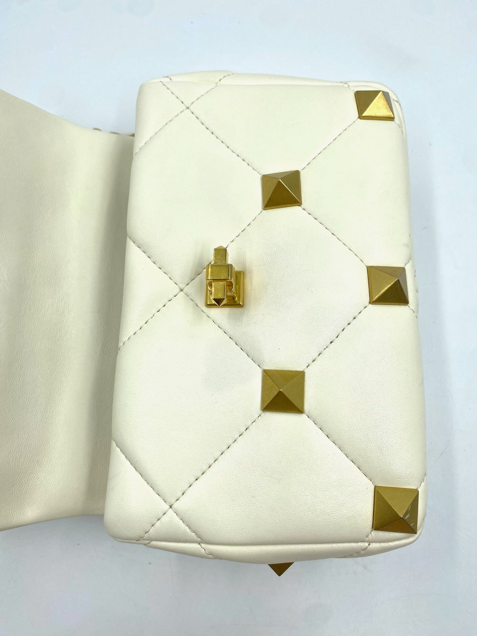 Valentino Garavani White Medium Roman Stud Bag, quilted leather with gold pyramid studs and clasp.