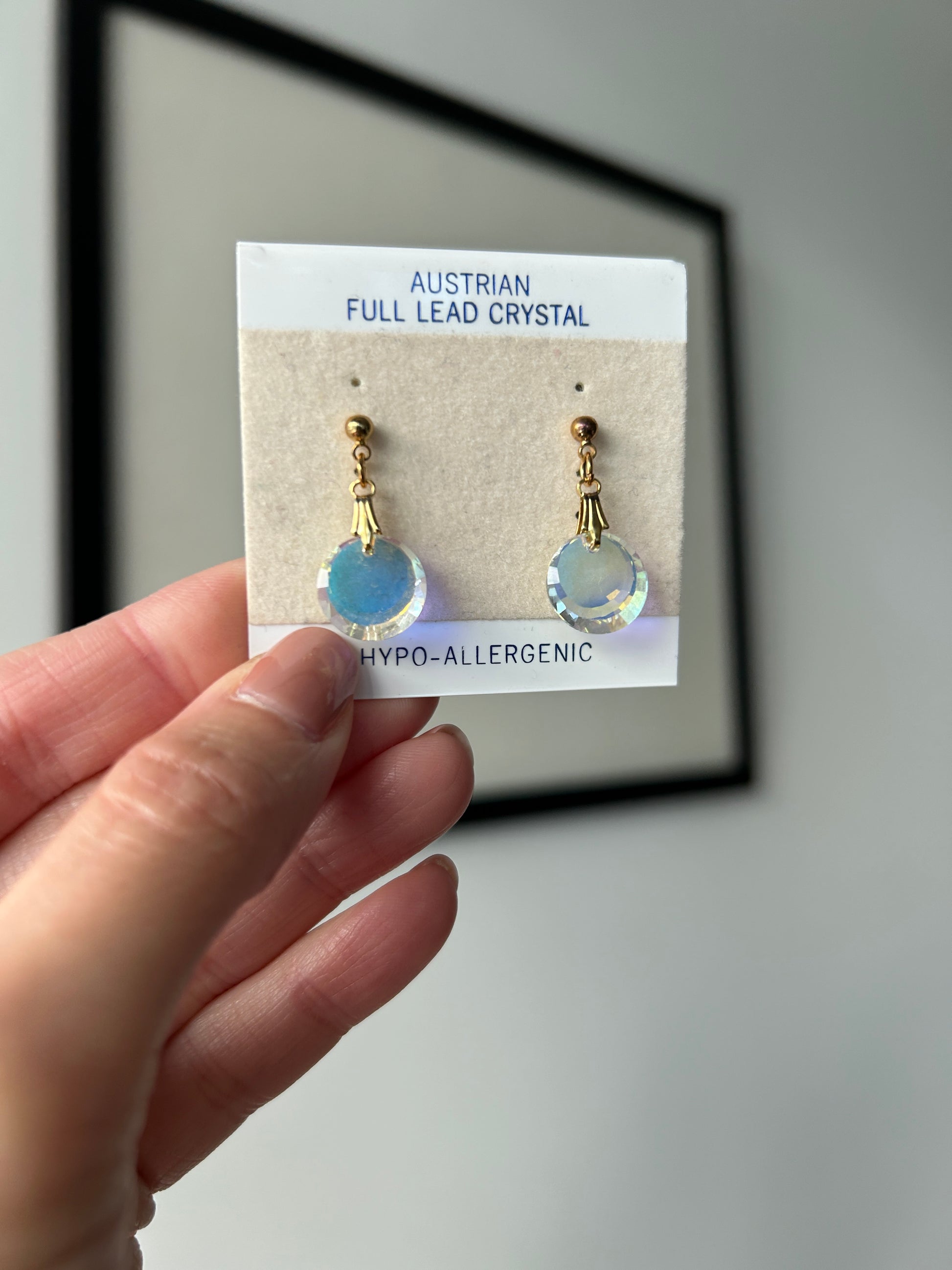 Vintage Austrian reflective crystal post earrings with gold-tone findings on original packaging.