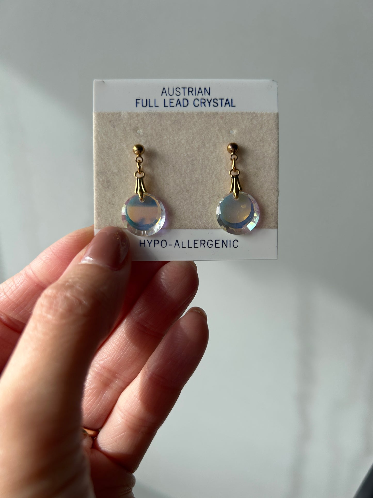 Vintage Austrian reflective crystal post earrings with gold-tone hardware on original packaging.
